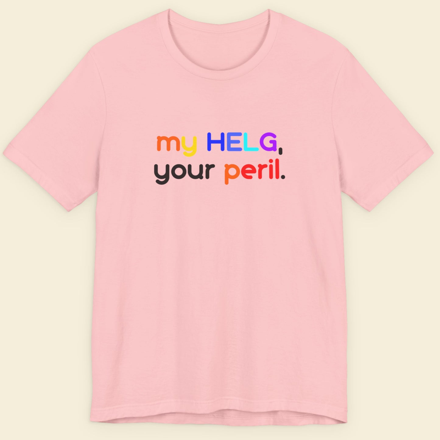 Pink t-shirt with colorful Swedish text on a beige background.