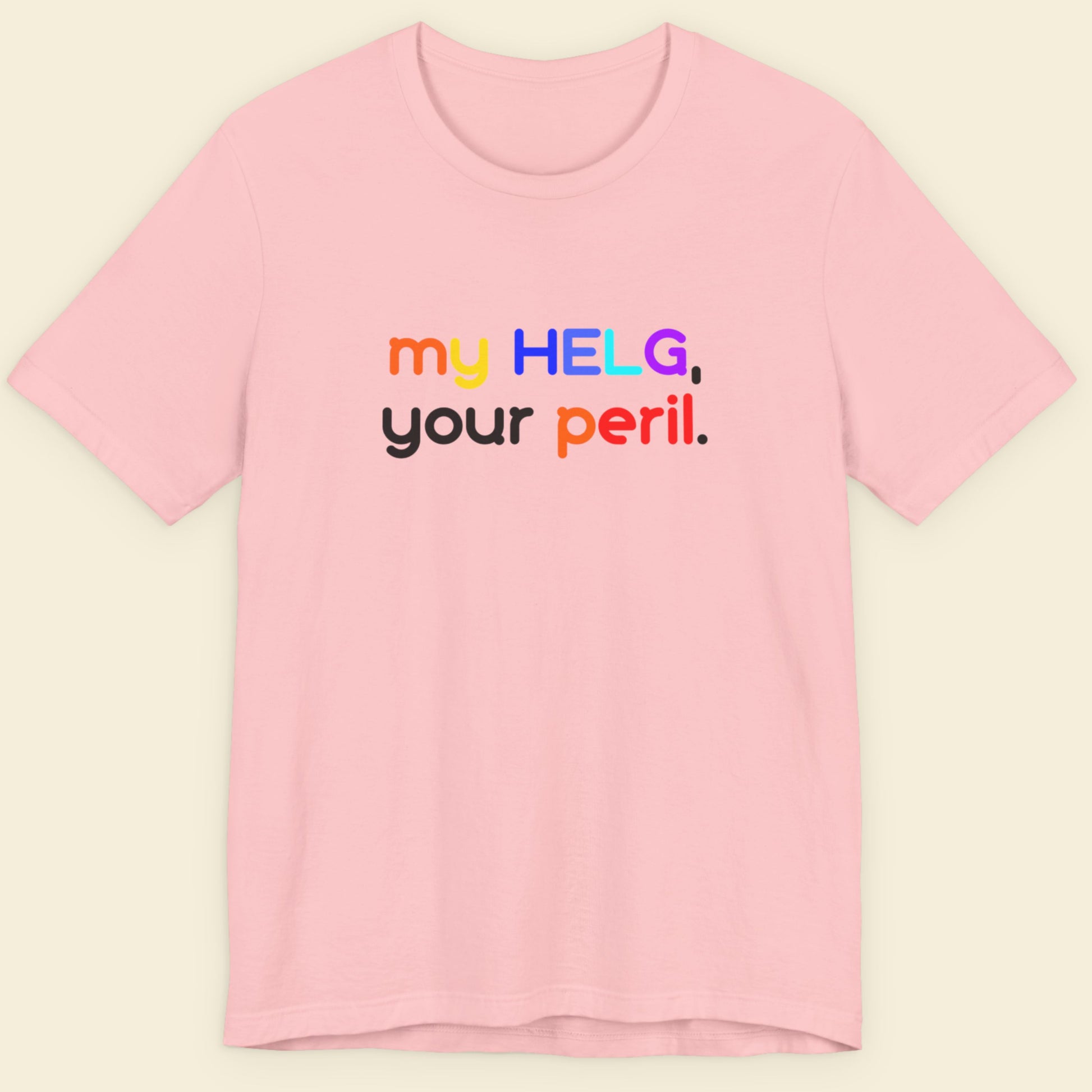 Pink t-shirt with colorful Swedish text on a beige background.