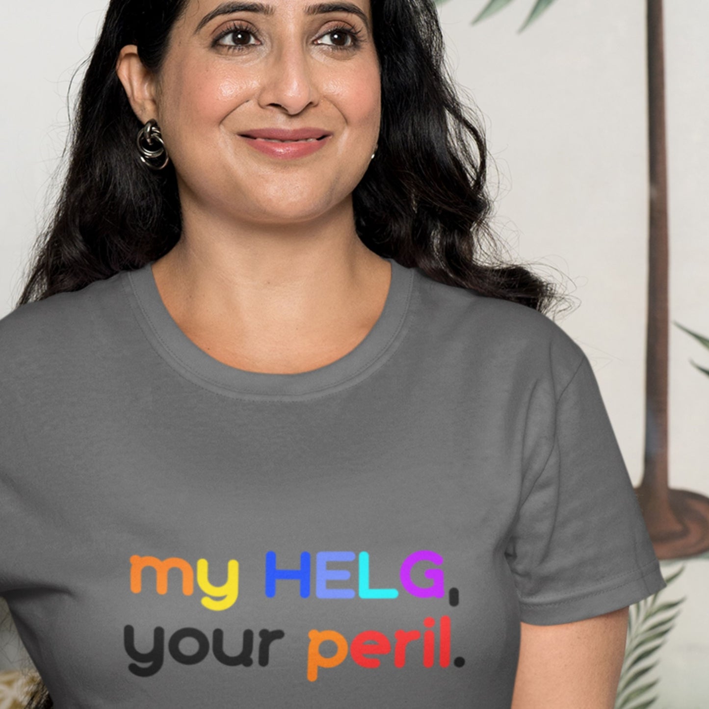 Woman wearing a gray t-shirt with colorful Swedish text.