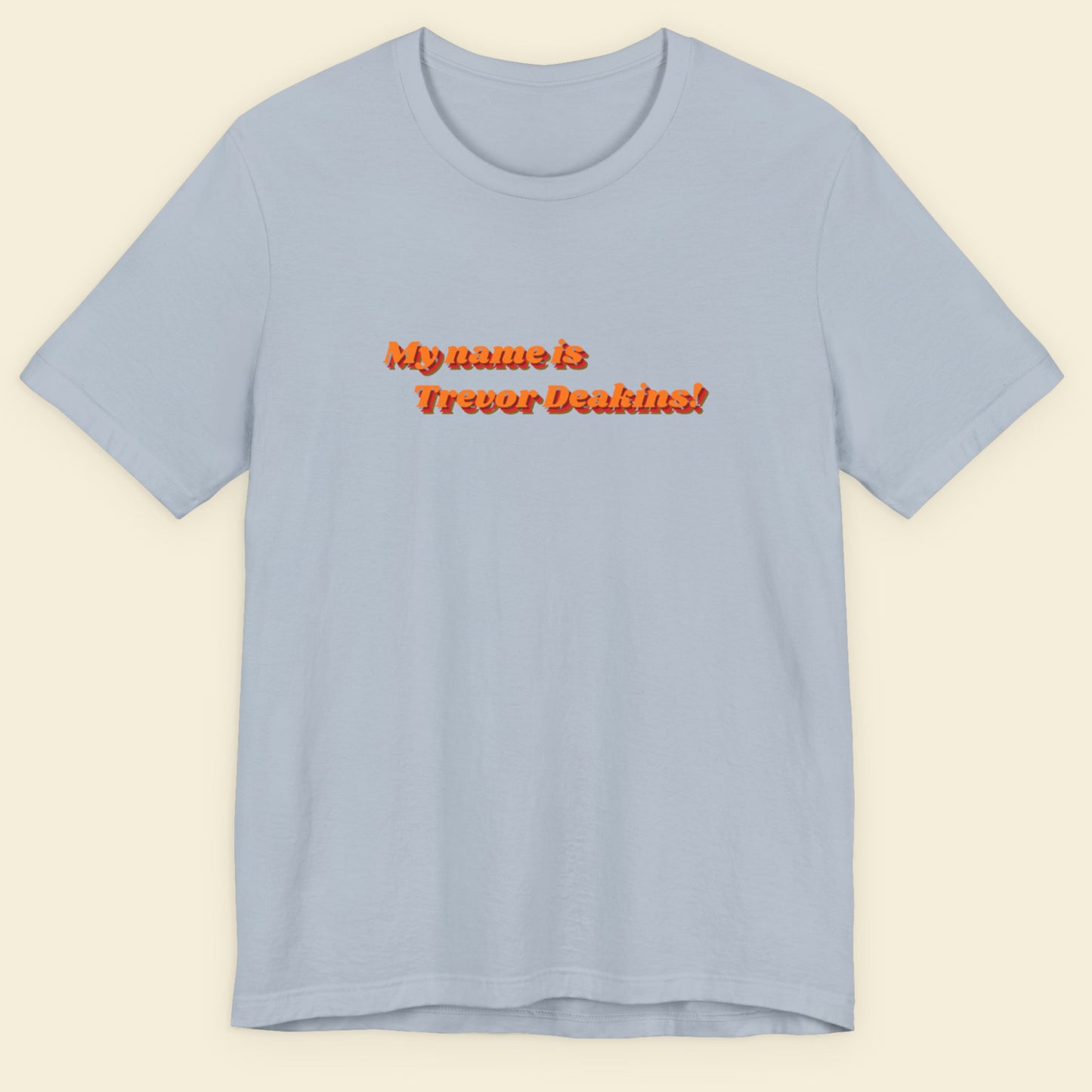 Light blue t-shirt with red text on a beige background
