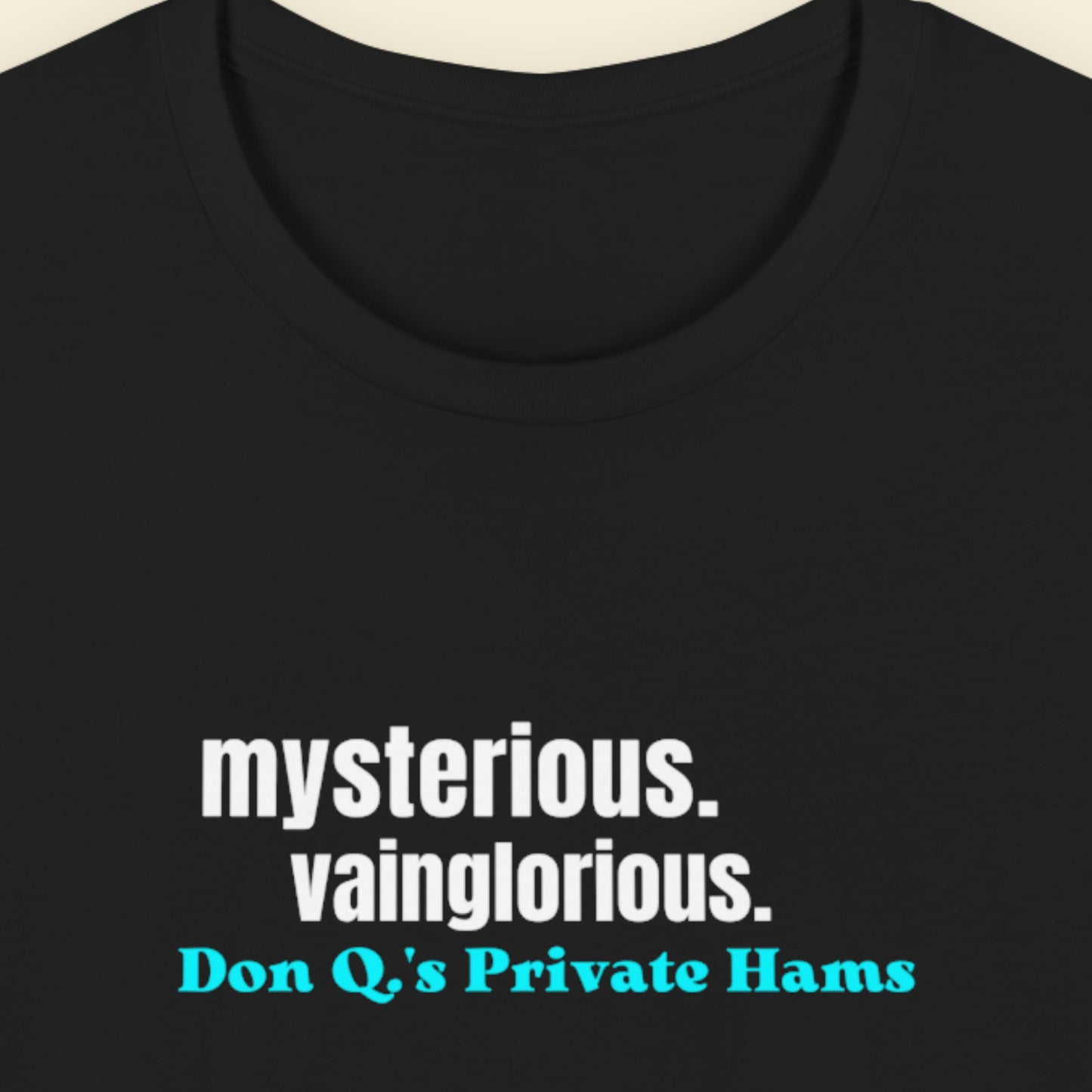 Black t-shirt with humorous colorful text on a beige background.