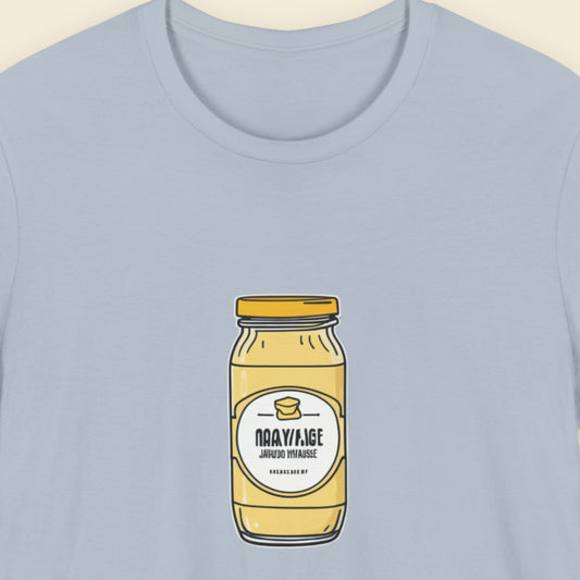 Light blue shirt with a drawing of a jar of specialty Dijonaise against a beige background.