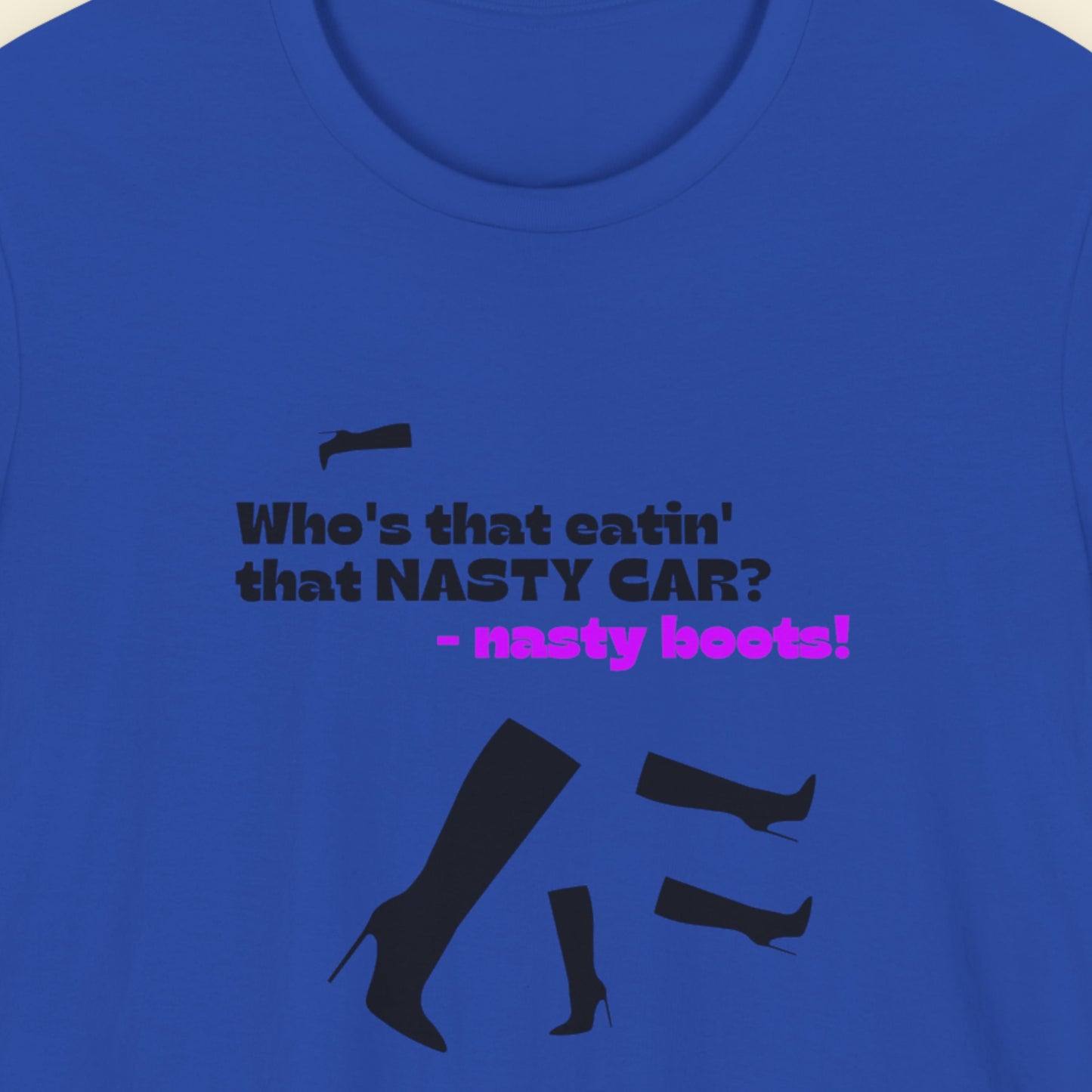 Blue t-shirt with humorous colorful text on a beige background.