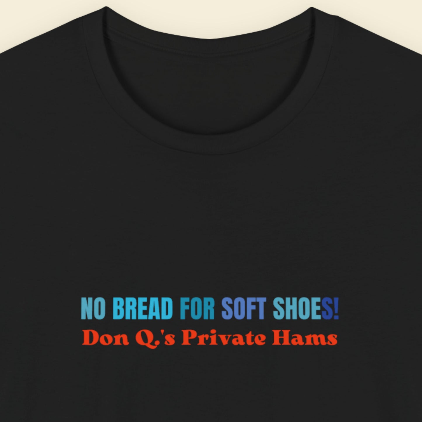 Black t-shirt with multicolored nonsensical text on a beige background.