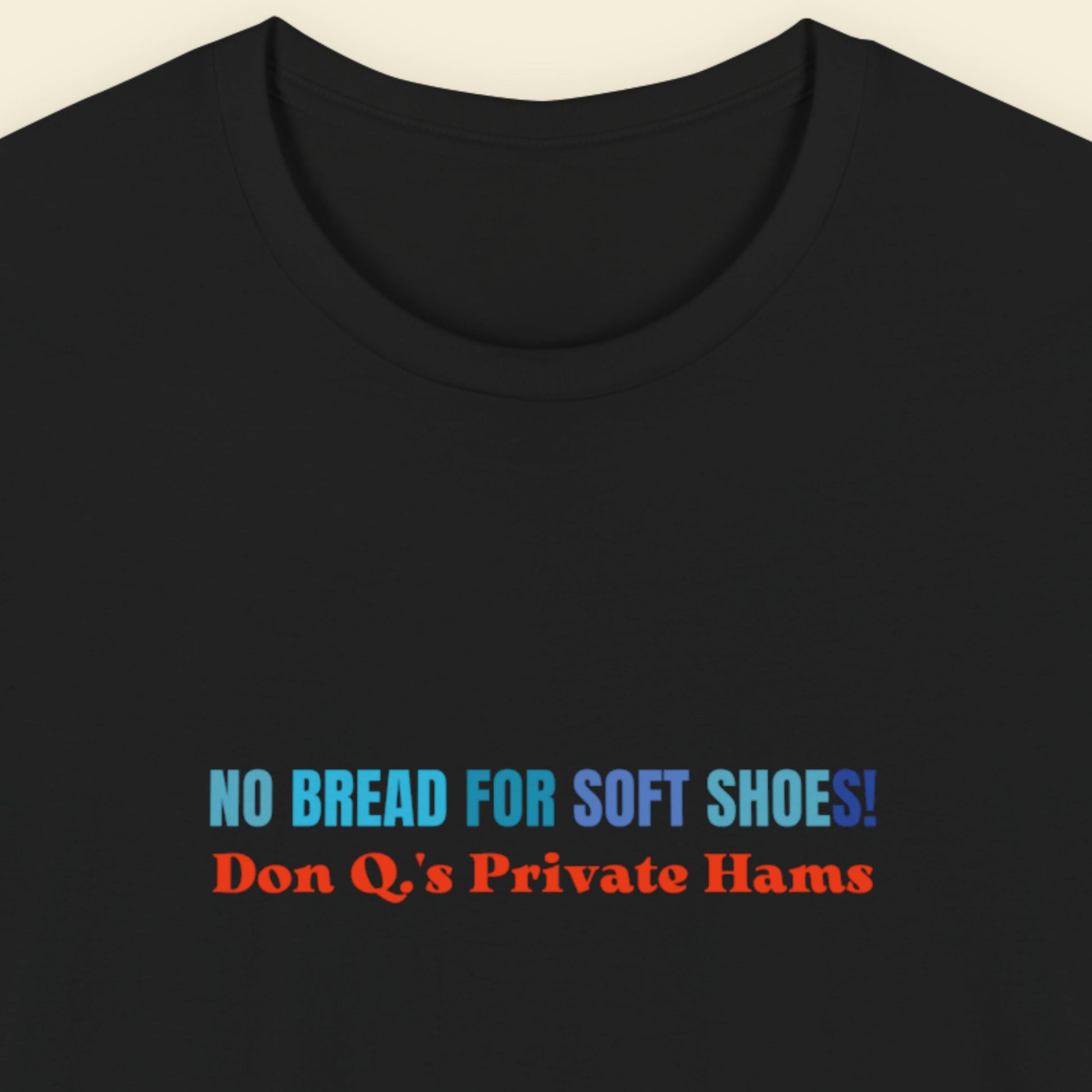 Black t-shirt with multicolored nonsensical text on a beige background.