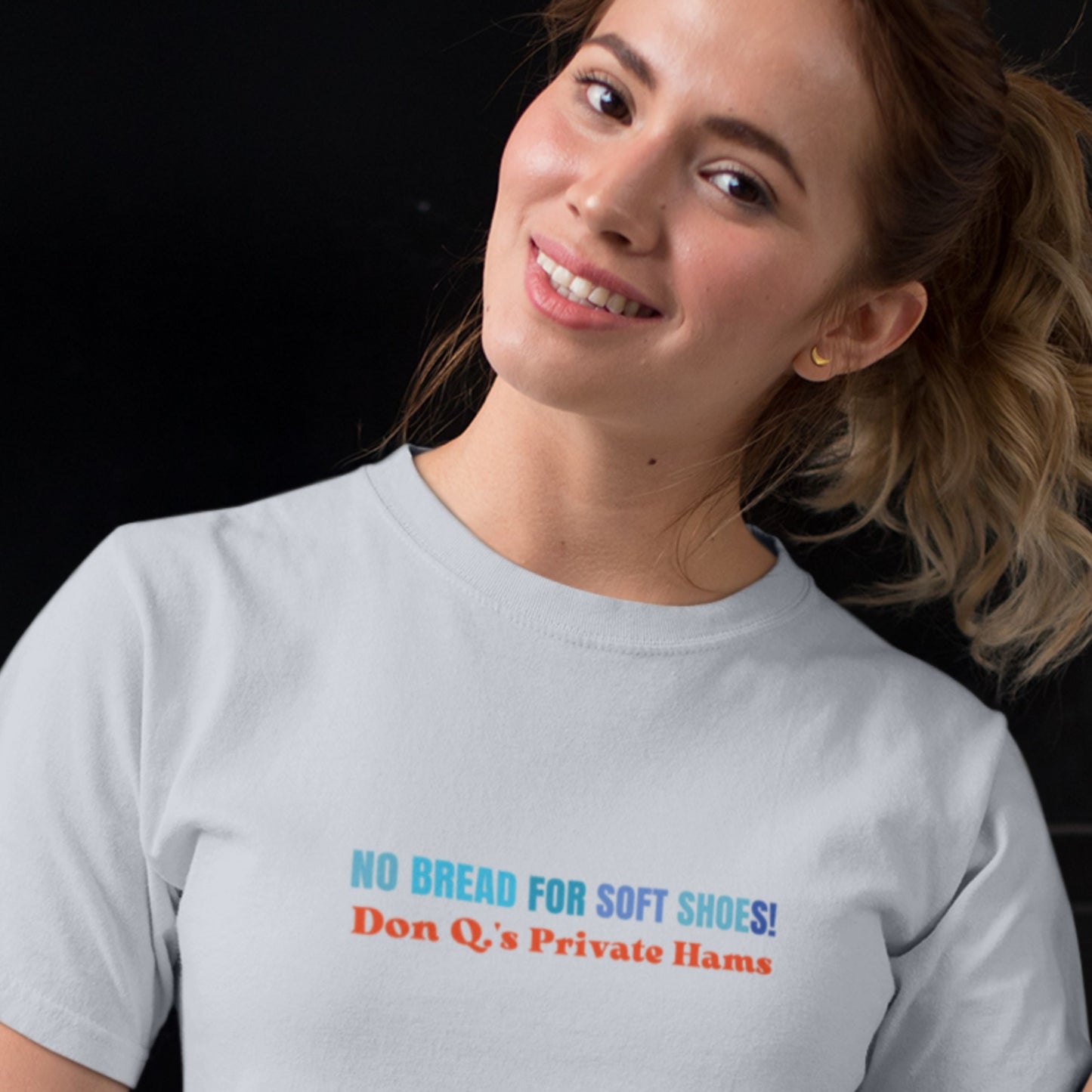 Woman wearing a gray t-shirt with colorful text