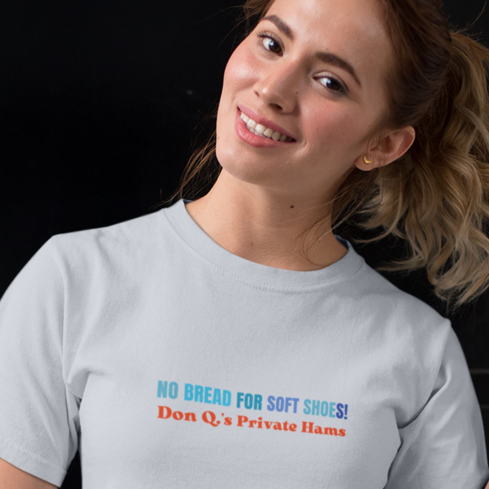 Woman wearing a gray t-shirt with colorful text