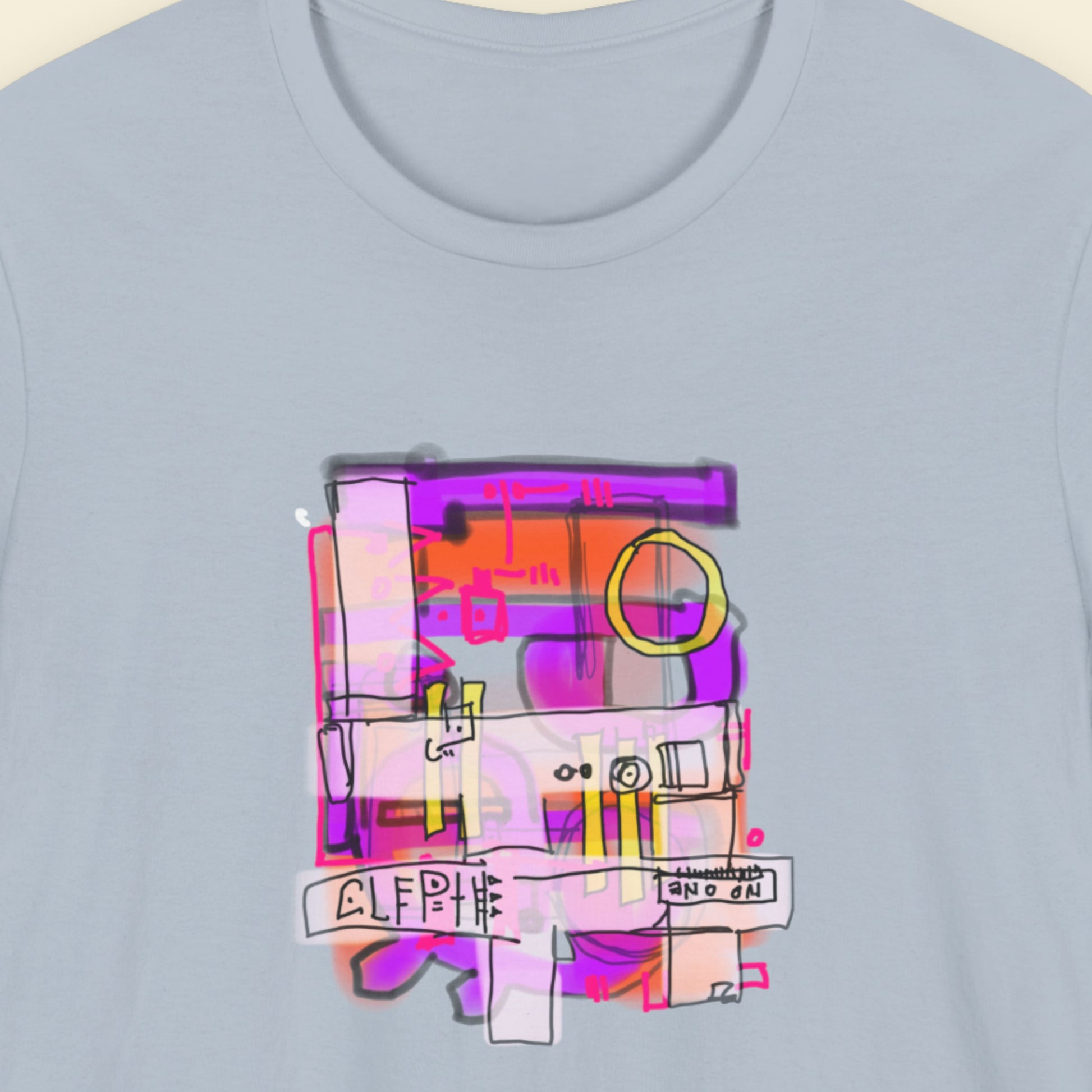 Light blue t-shirt with a colorful abstract drawing on a beige background.