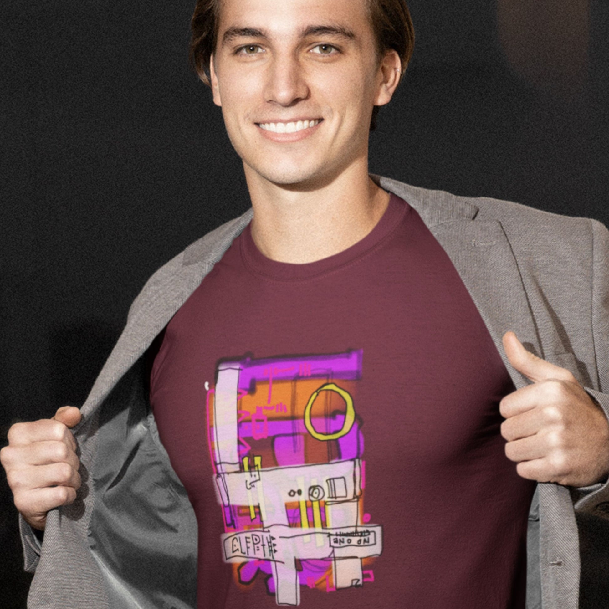 Man wearing a maroon t-shirt with a colorful abstract drawing on a grey background.
