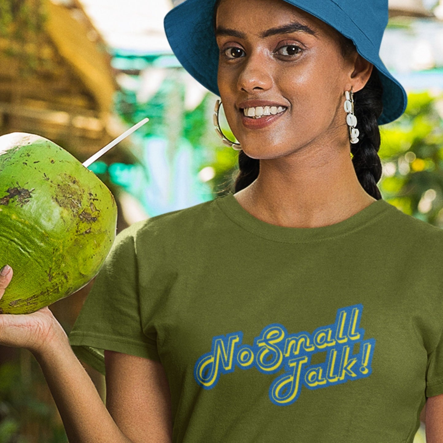 Woman holding a green coconut and wearing a green t-shirt with 'No Small Talk!' text.