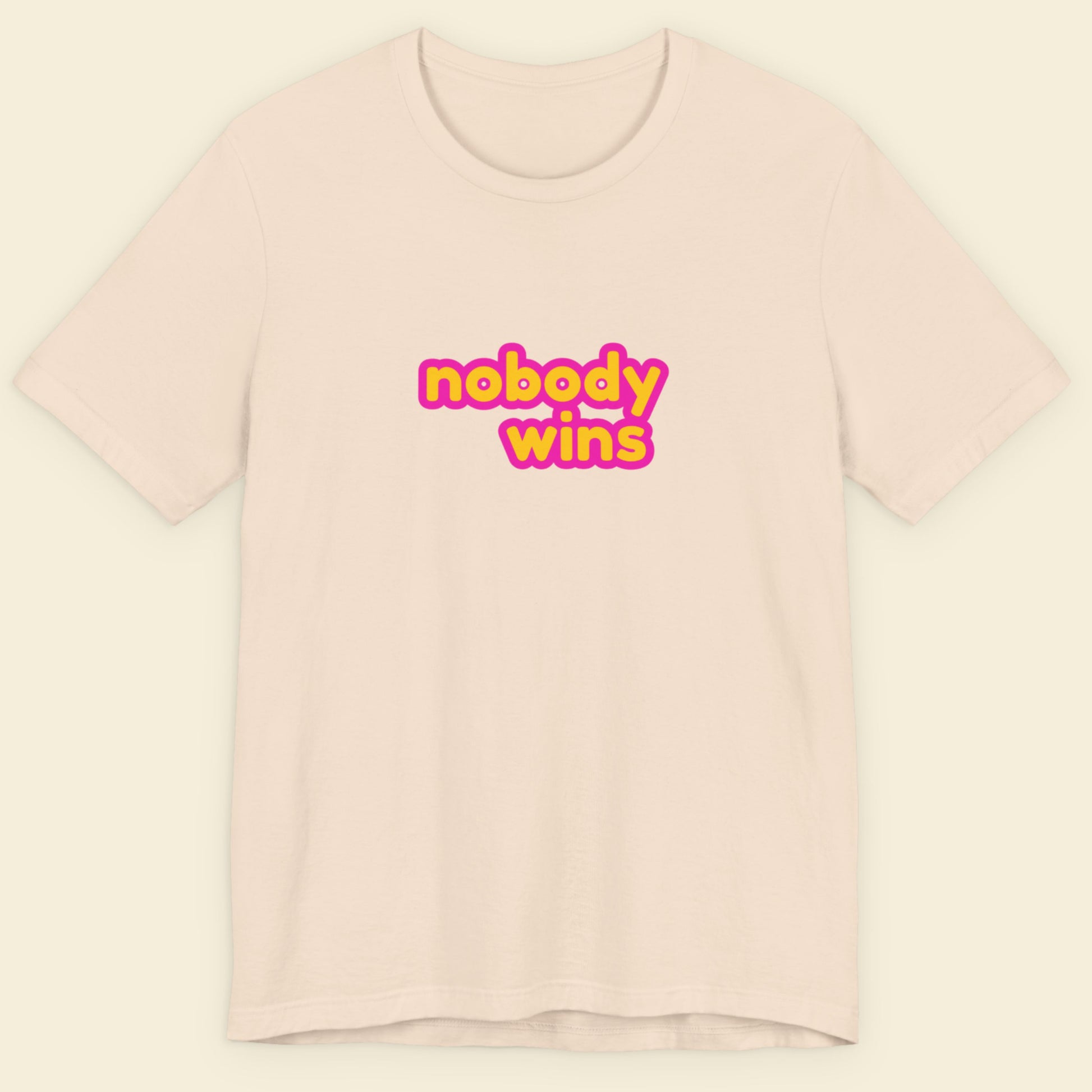 Beige t-shirt with 'nobody wins' text in yellow and pink on a light beige background
