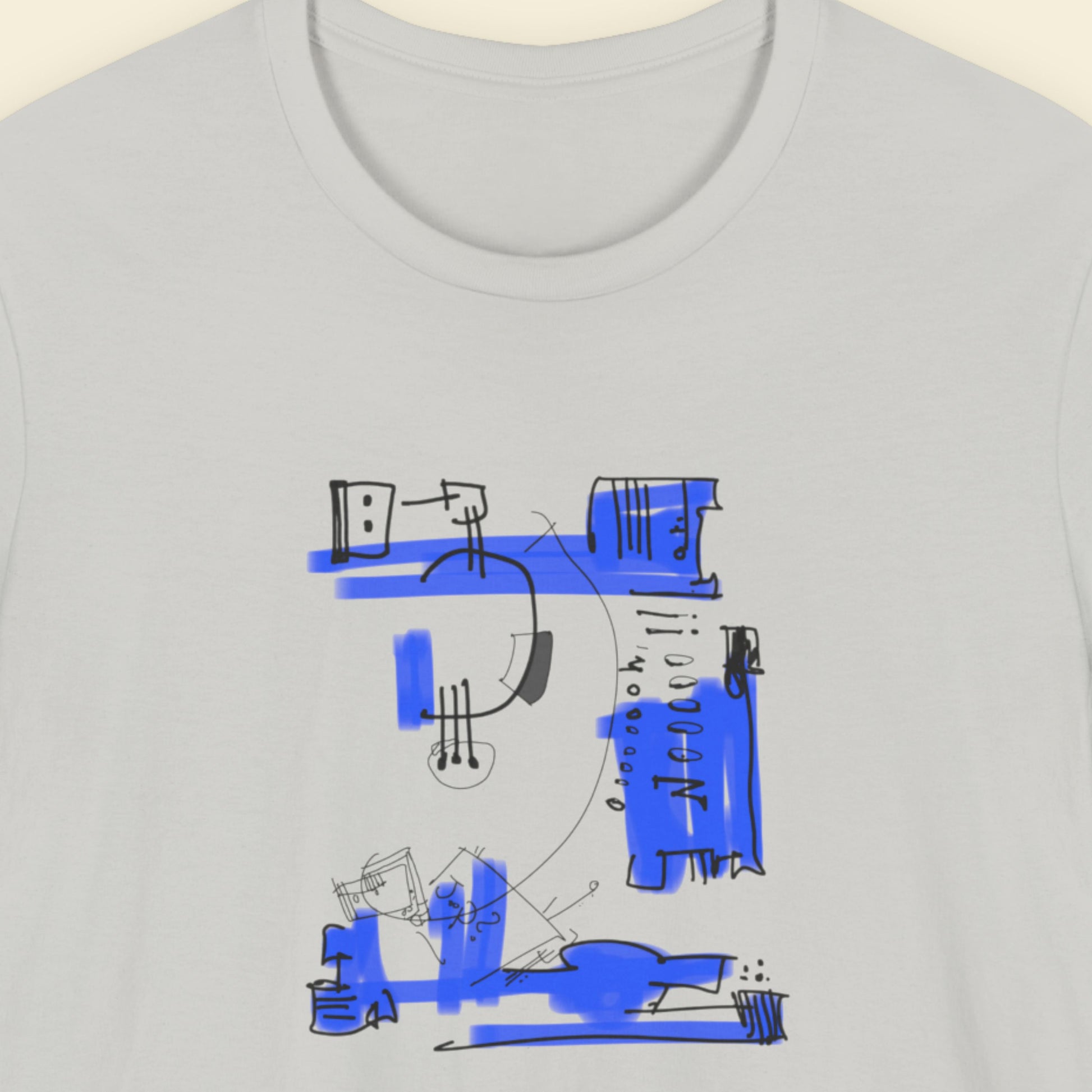 Light grey t-shirt with a colorful abstract drawing on a beige background.