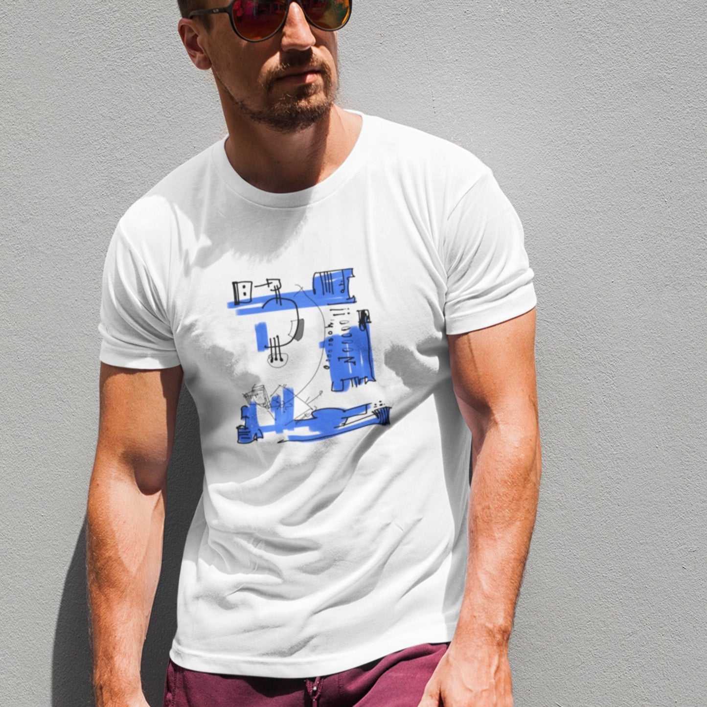 Buff guy wearing an awesome white t-shirt with a colorful abstract drawing on a grey background.