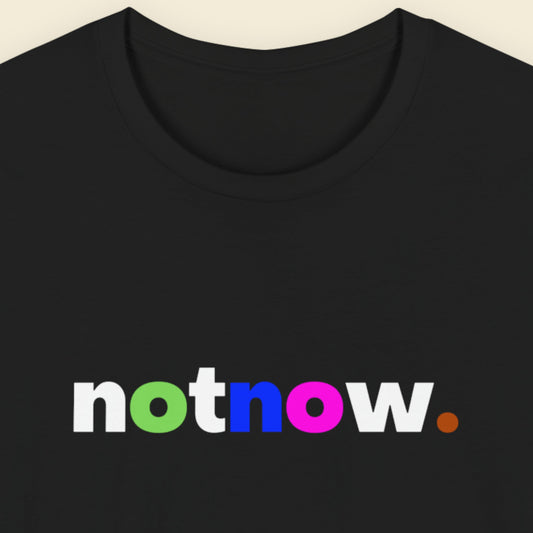Black t-shirt with 'notnow' text in multicolor on a beige background.