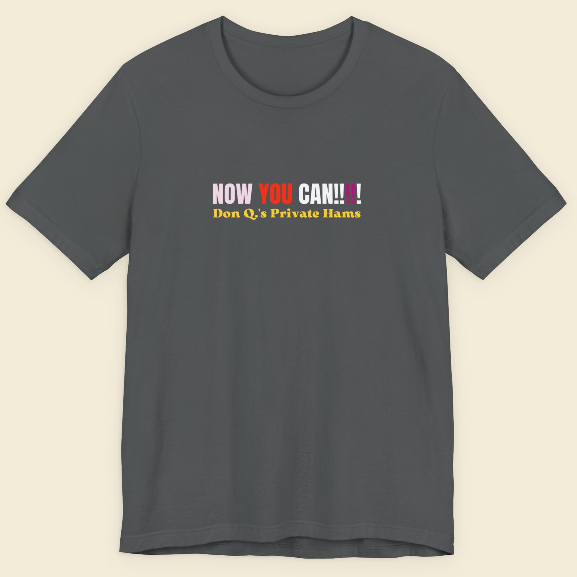 Gray t-shirt with colorful text on a beige background.
