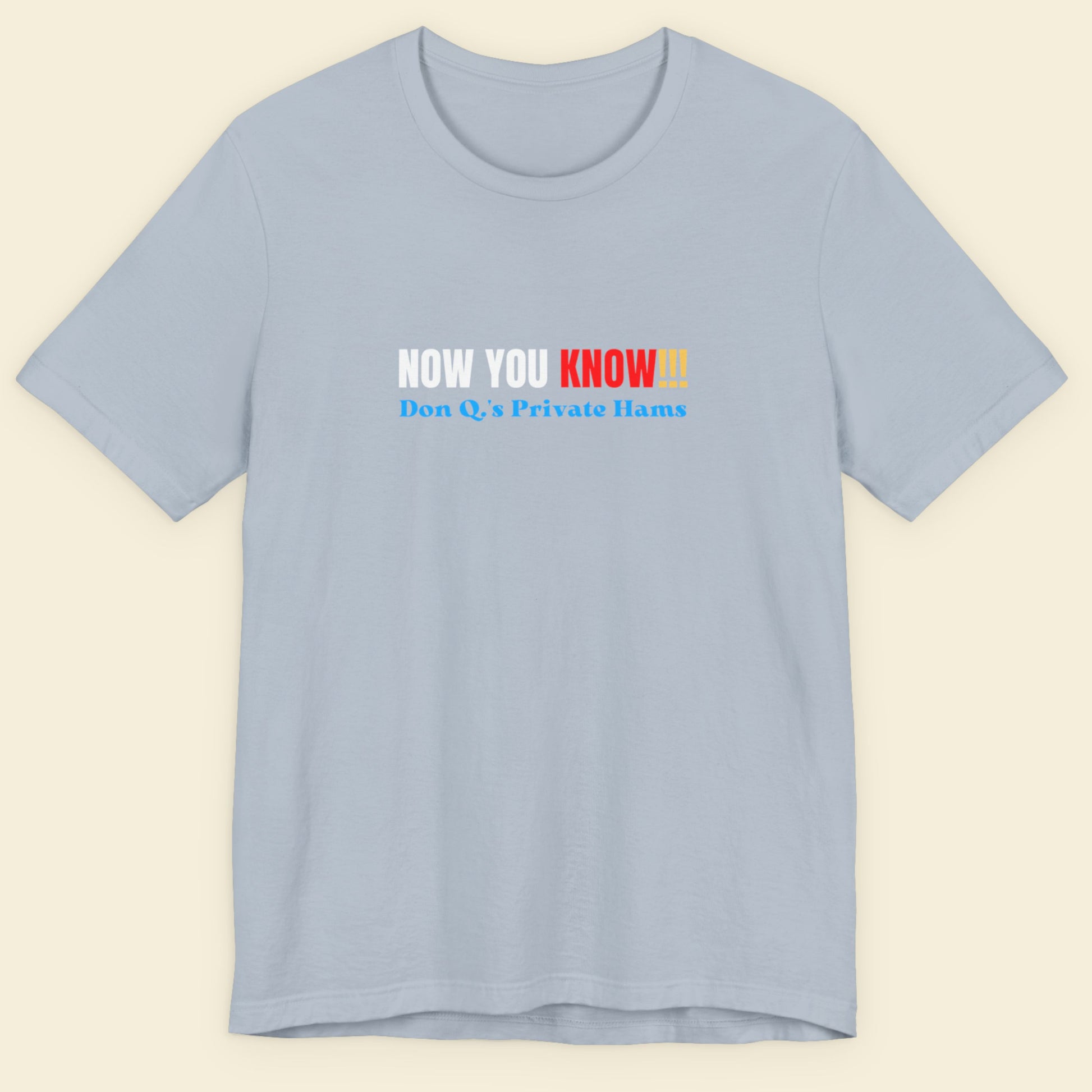 Light blue t-shirt with multicolored 'now you know!!!' text on a beige background.