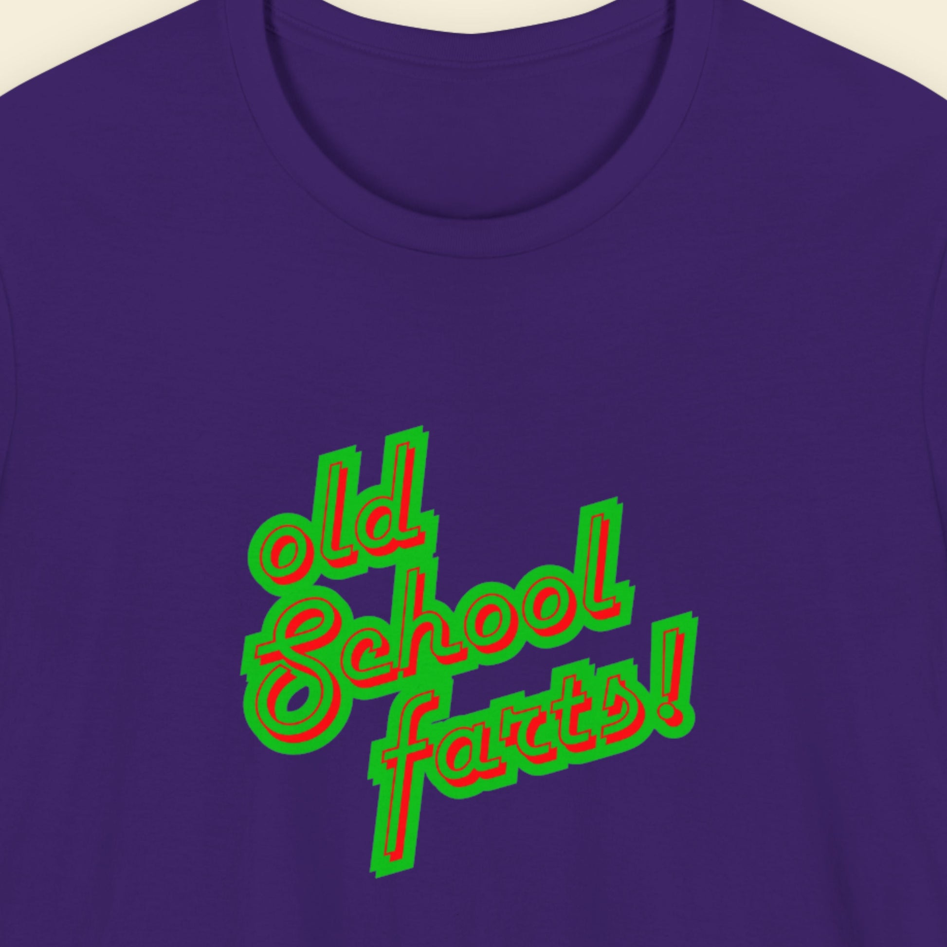 Navy t-shirt with humorous colorful text on a beige background.