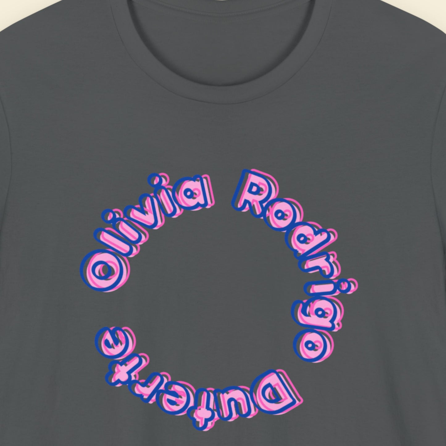 Grey t-shirt with multicolored 'Olivia Rodrigo Duterte' text on a beige background.