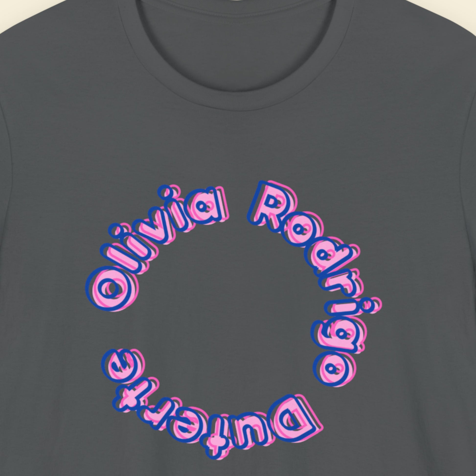Grey t-shirt with multicolored 'Olivia Rodrigo Duterte' text on a beige background.