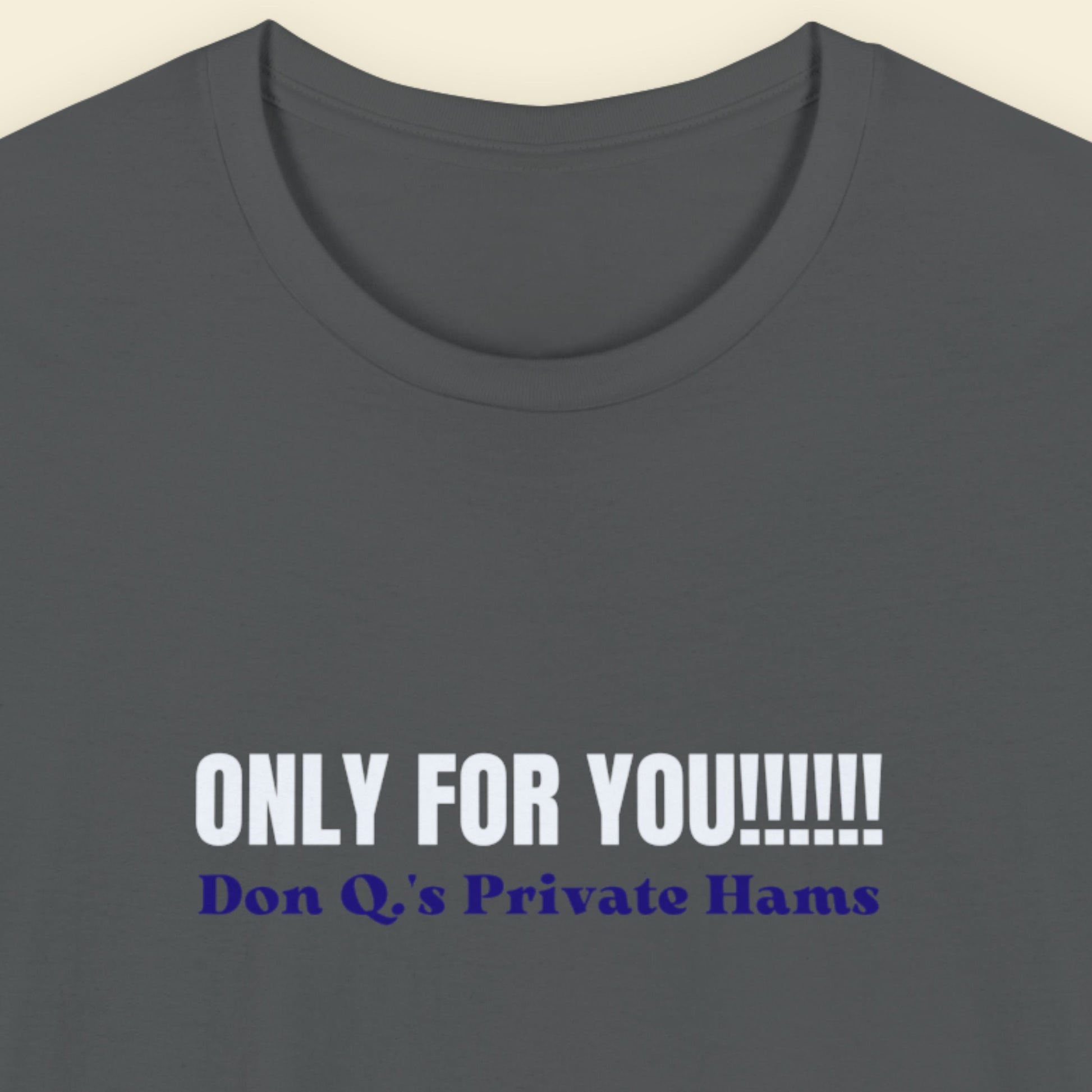 Grey t-shirt with nonsensical text on a beige background.