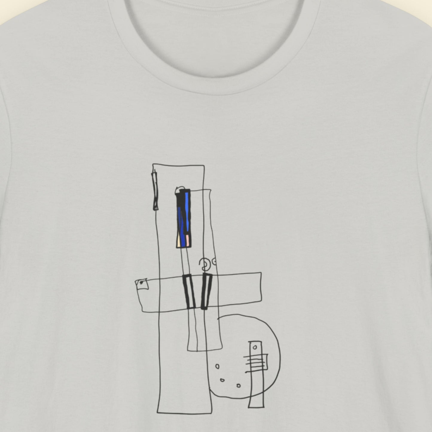 Light grey t-shirt with an abstract drawing on a beige background.