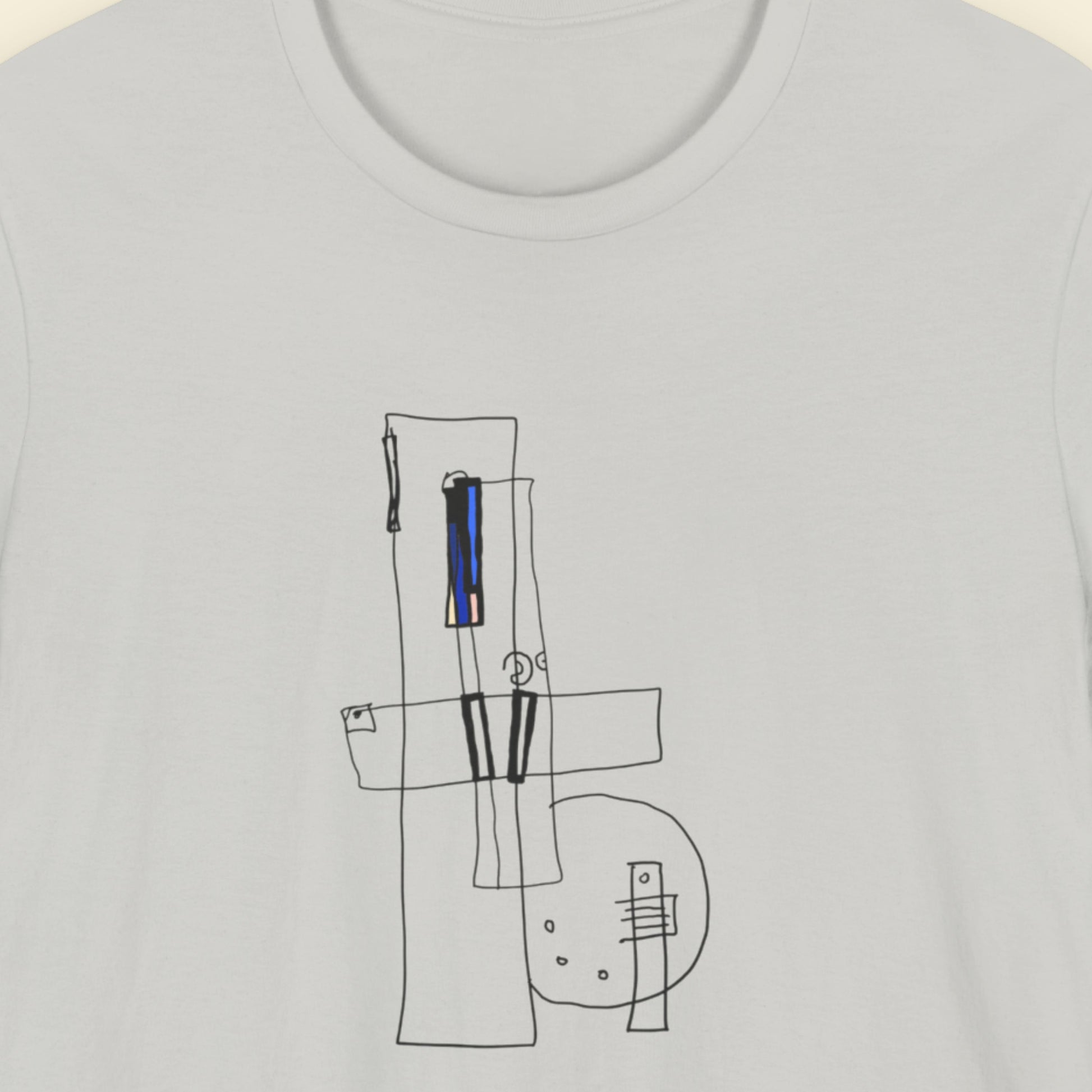 Light grey t-shirt with an abstract drawing on a beige background.