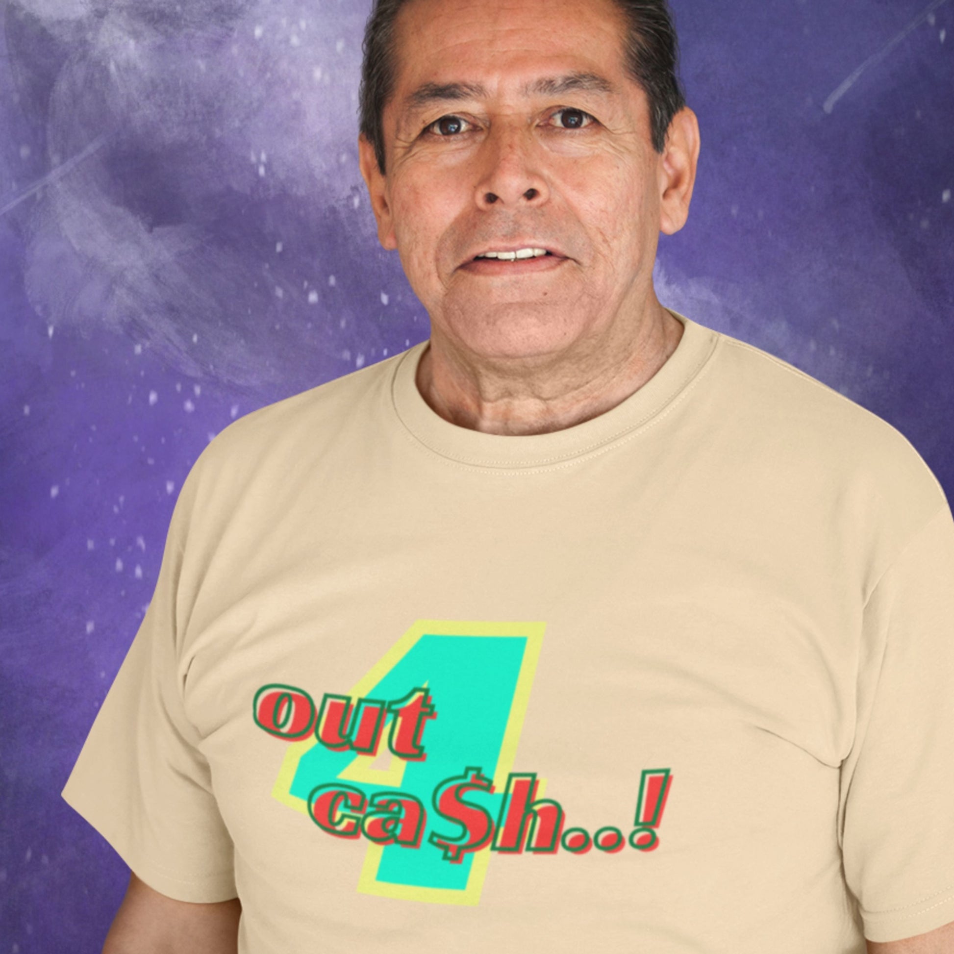 Man wearing a beige t-shirt with multicolored 'out 4 ca$h..!' text while floating through space.