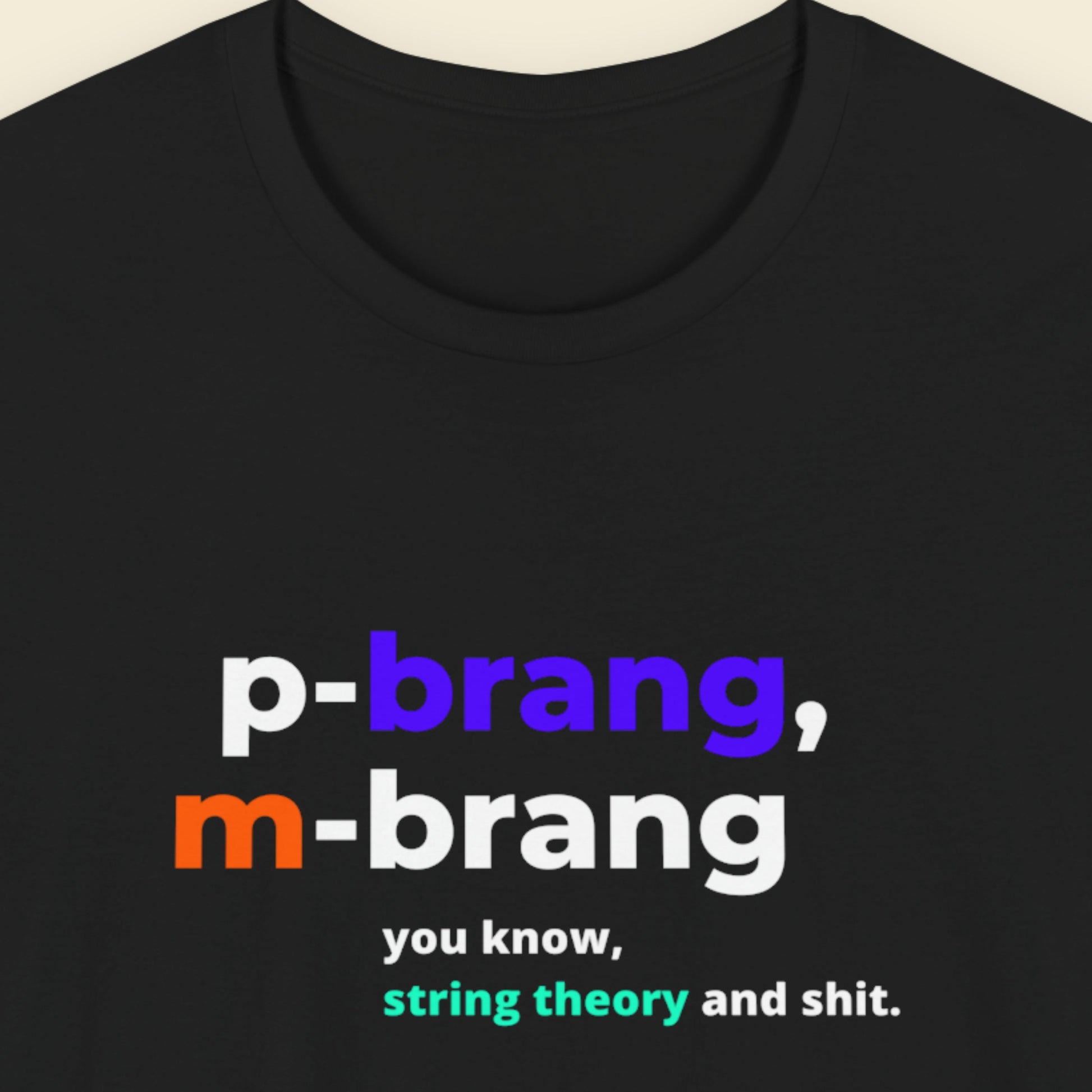 Black t-shirt with colorful text design on a beige background.