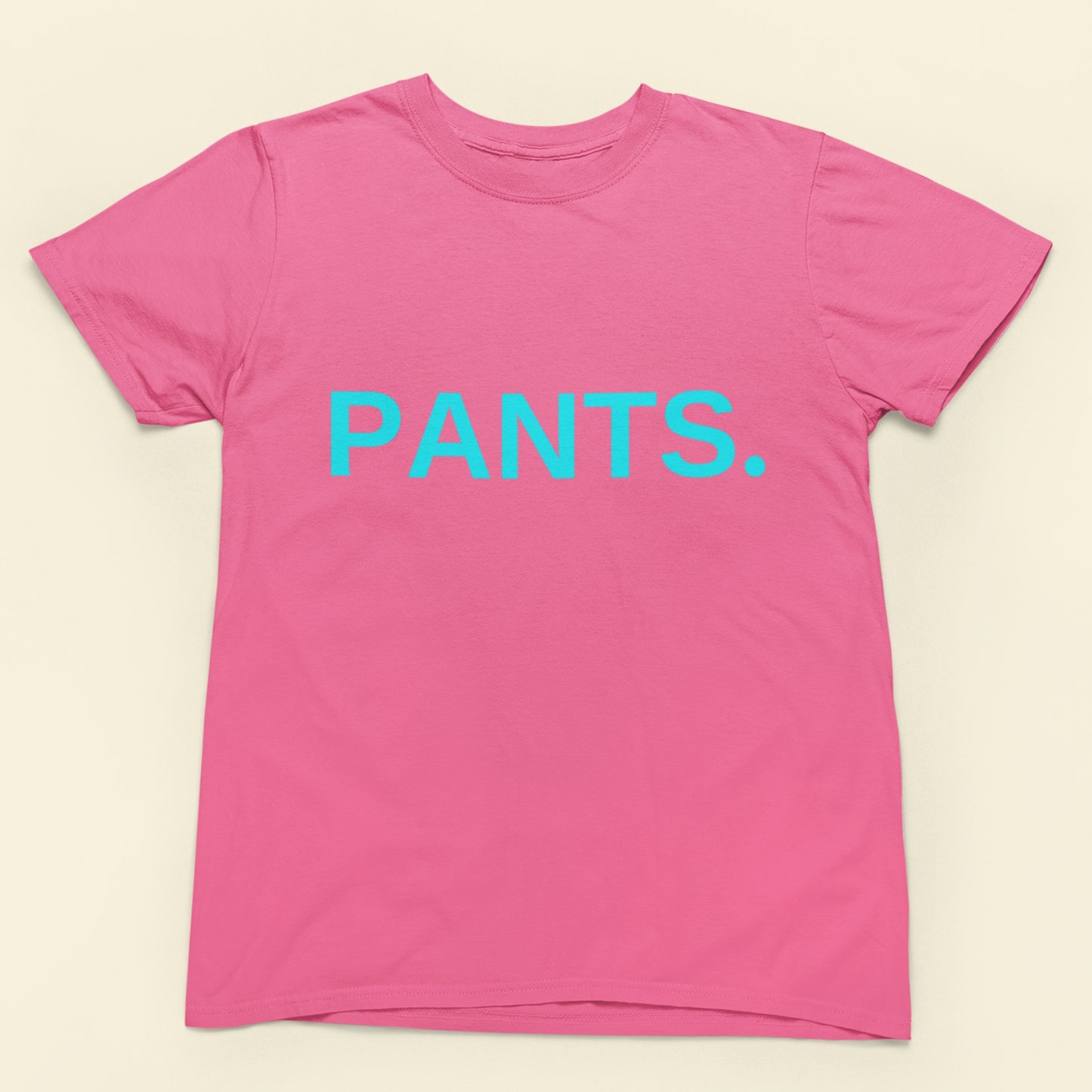 Pink t-shirt with 'PANTS.' in blue text on a beige background