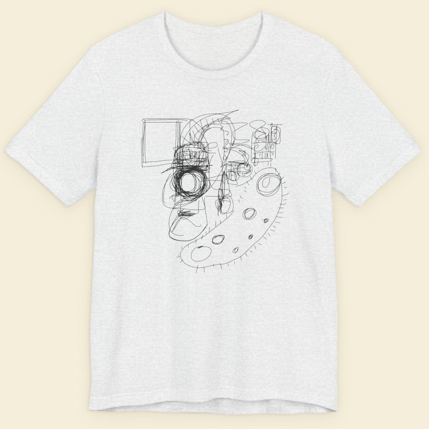 Ashy grey t-shirt with black abstract design on a beige background.