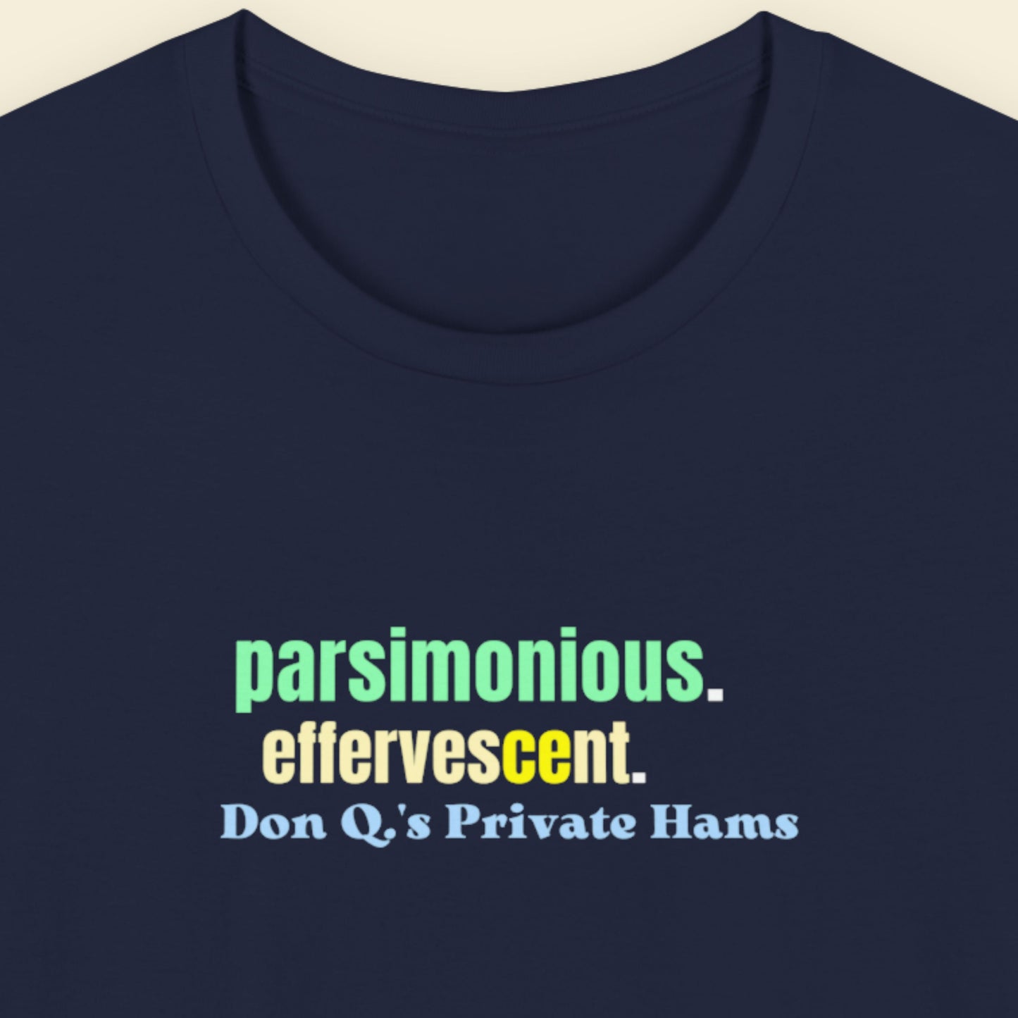 Navy Blue t-shirt with humorous colorful text on a beige background.