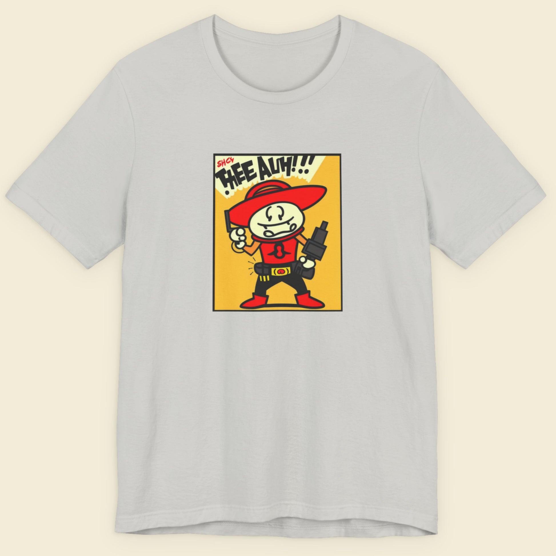 Gray t-shirt with a cartoon character graphic on a beige background.