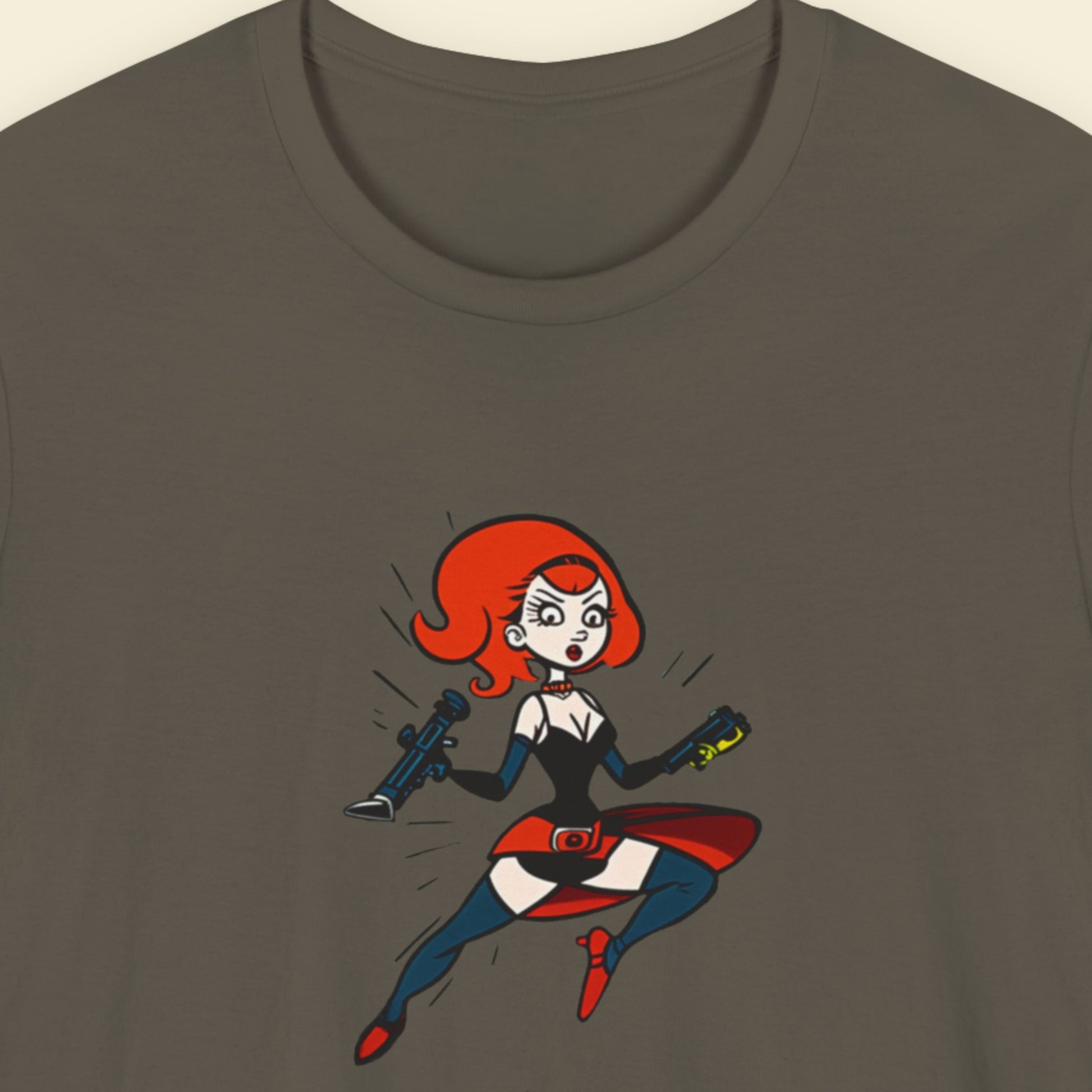 Army green t-shirt with a fun, colorful cartoon hero illustration on a beige background.
