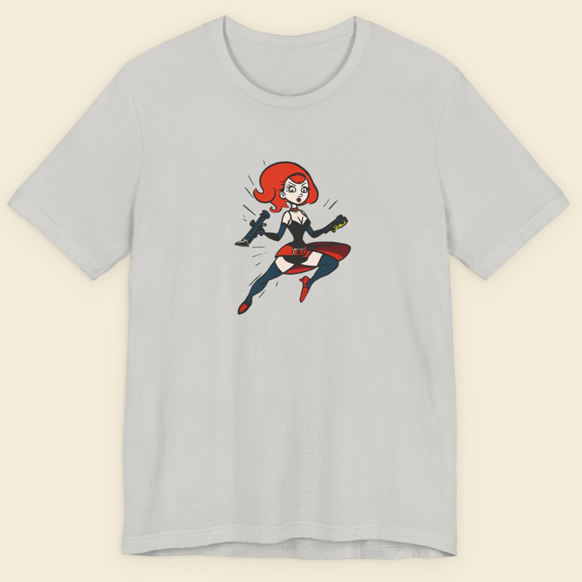 Light grey t-shirt with a fun, colorful cartoon hero illustration on a beige background.