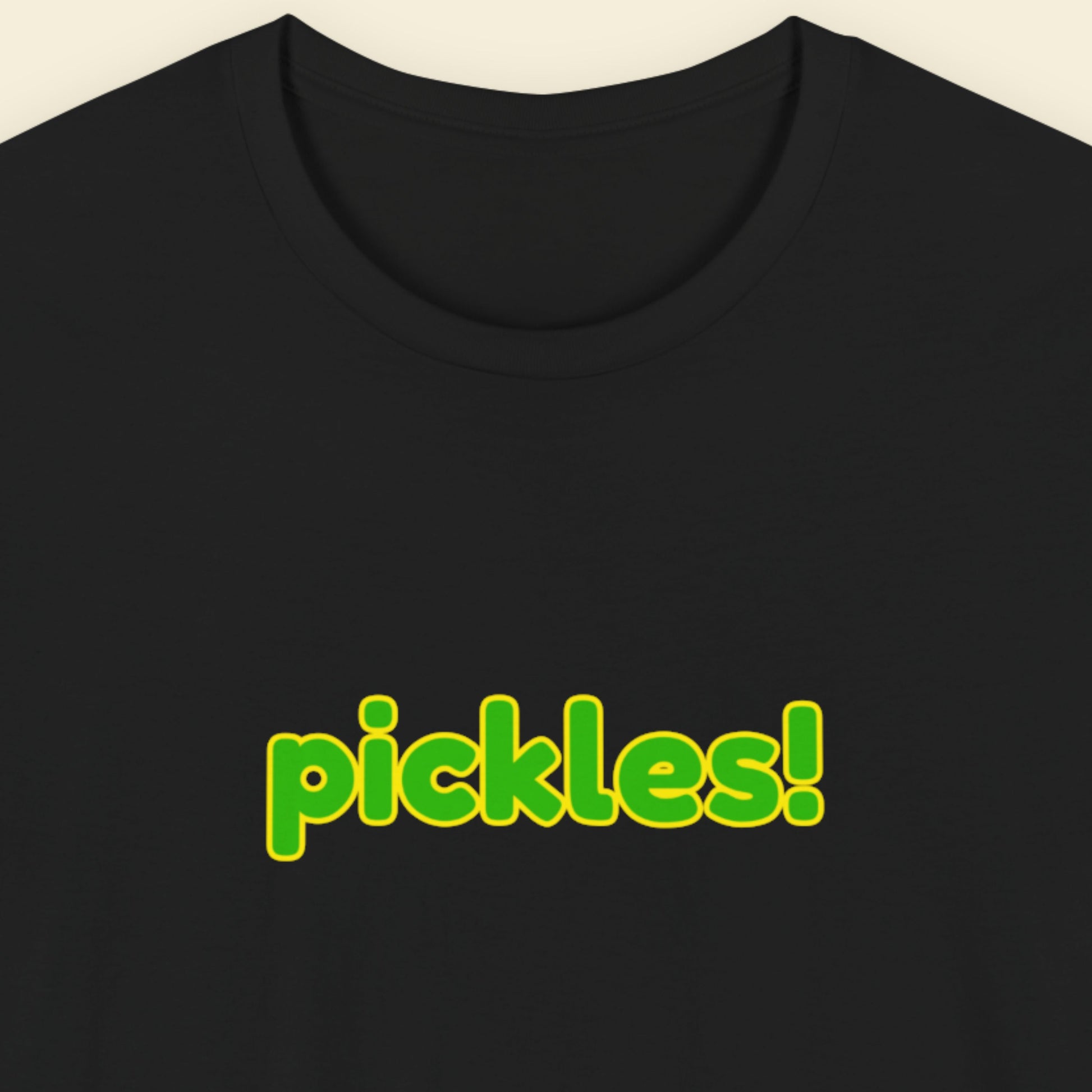 Black t-shirt with humorous colorful pickles! text on a beige background.