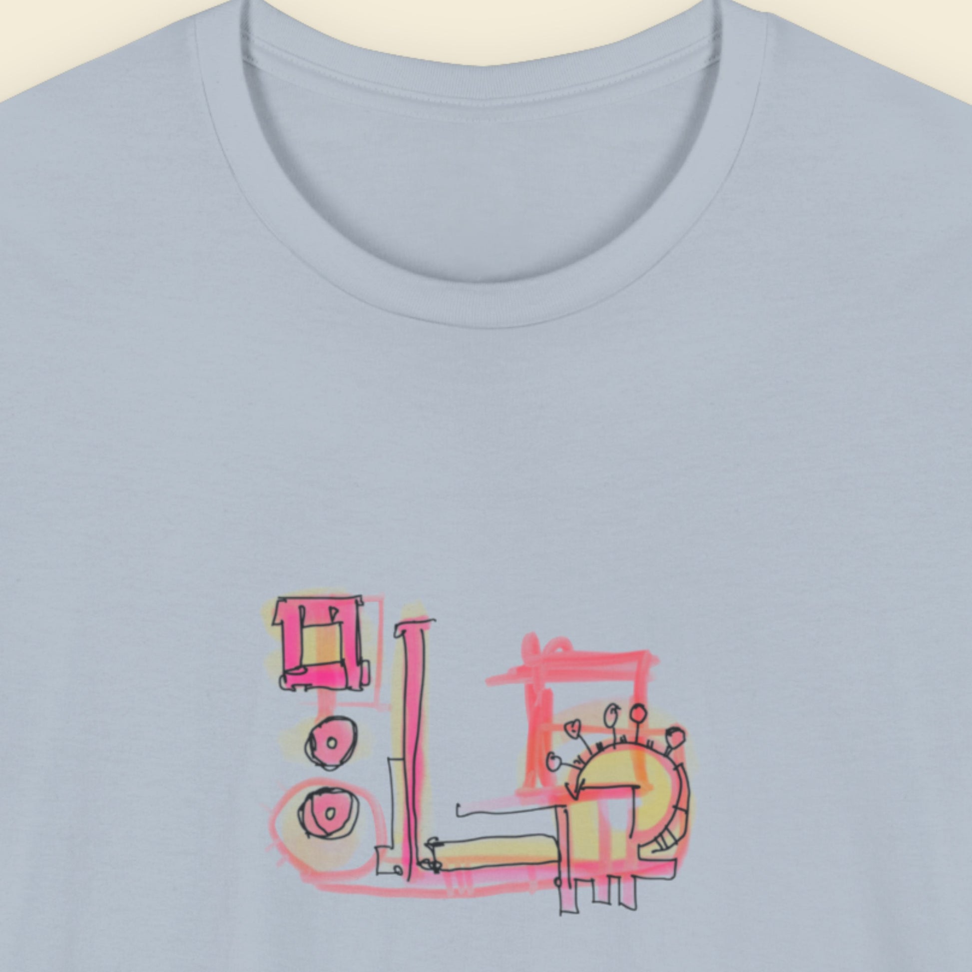 Light blue t-shirt with a colorful abstract graffiti drawing on a beige background.