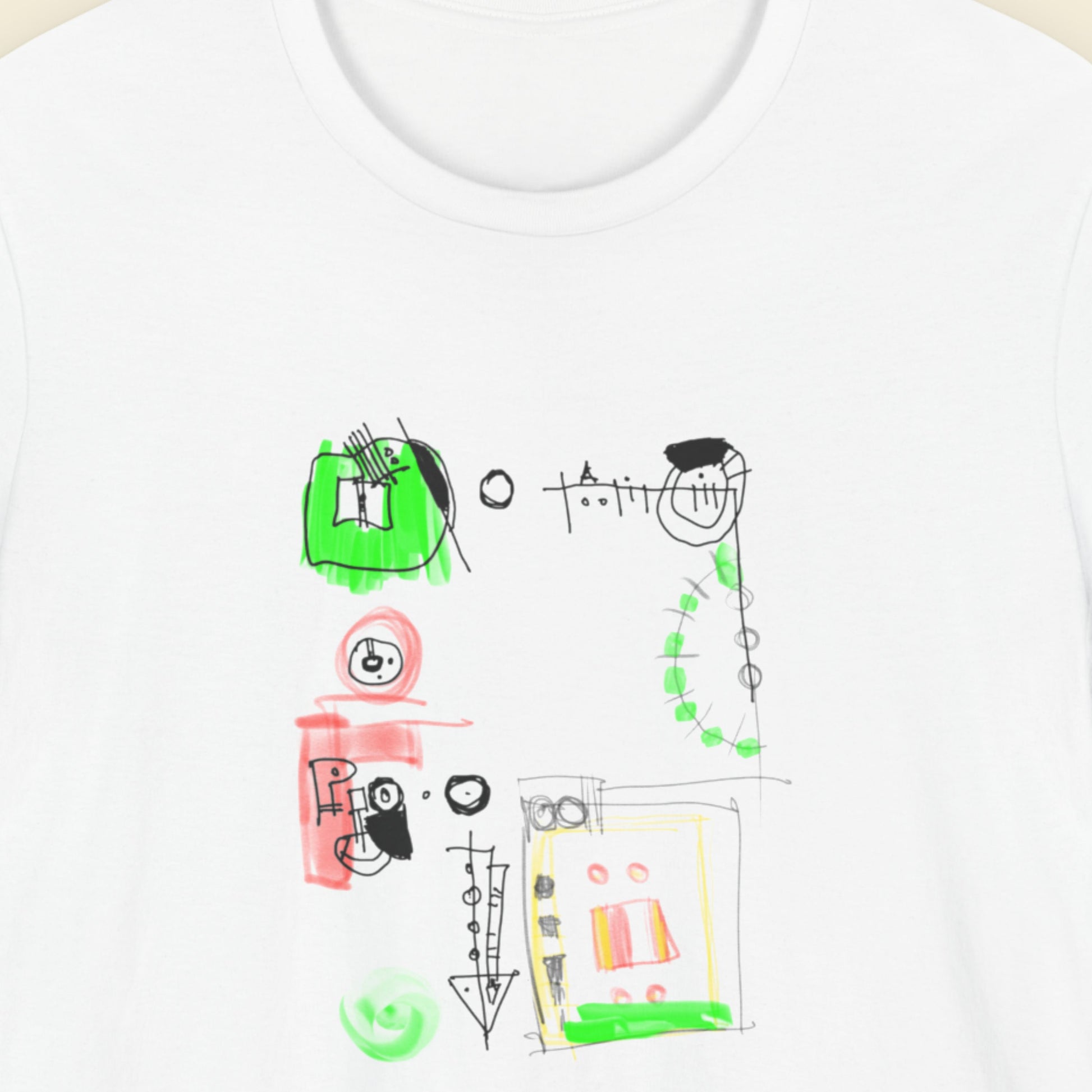 White shirt with a colorful abstract drawing on a beige background.