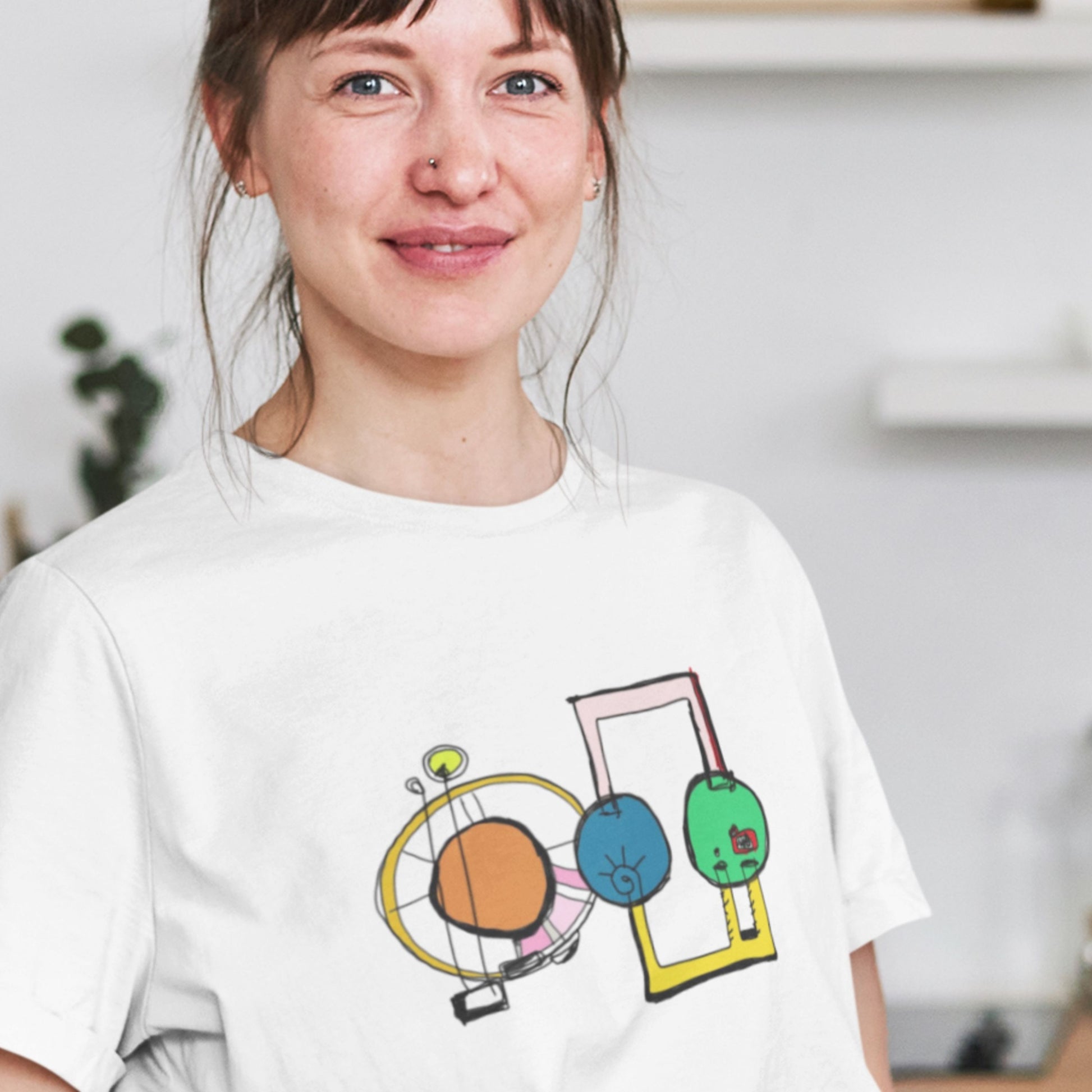 Person wearing a white t-shirt with colorful graphic design.