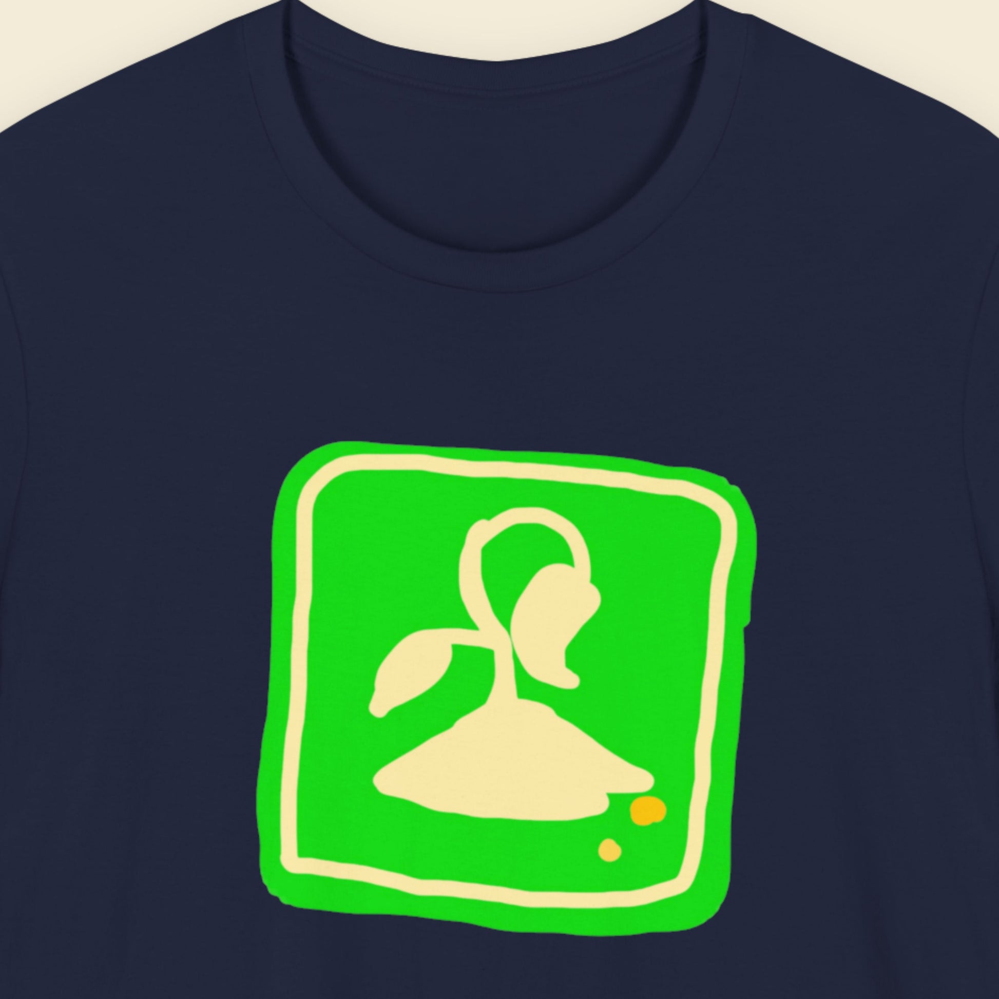 Navy blue t-shirt with a fun, colorful illustration on a beige background.
