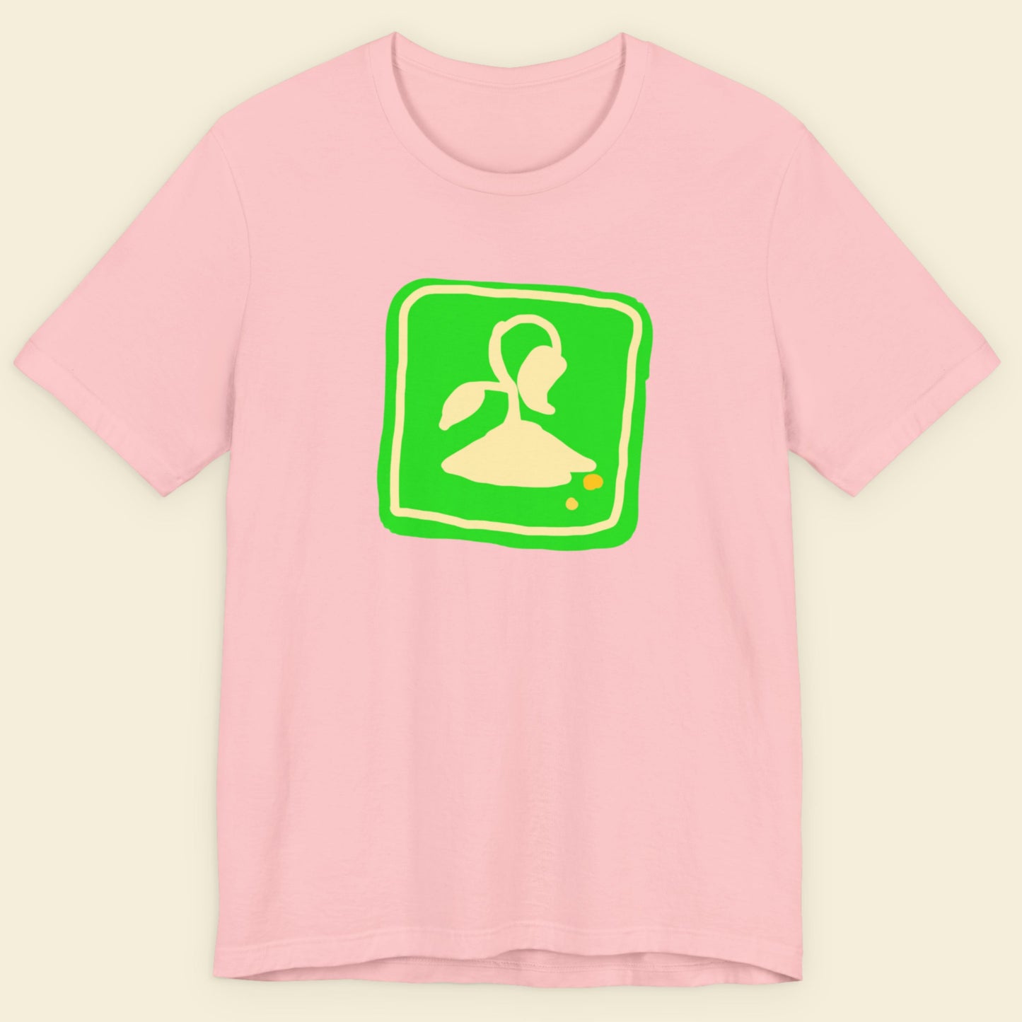 Pink t-shirt with a fun, colorful illustration on a beige background.