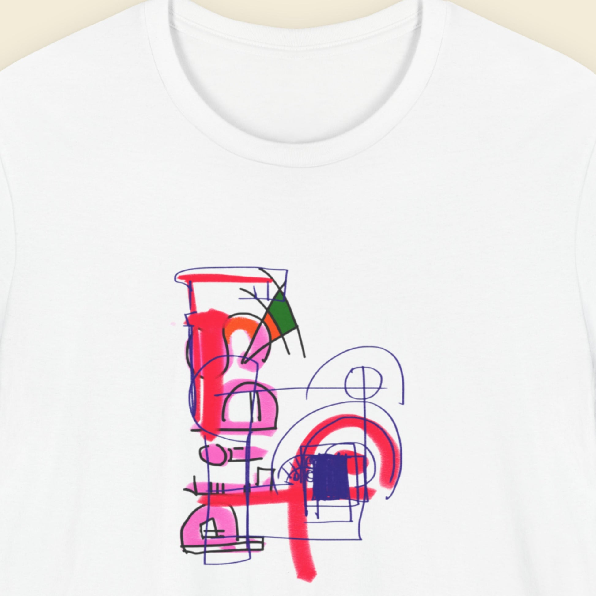 White t-shirt with a colorful abstract drawing on a beige background.
