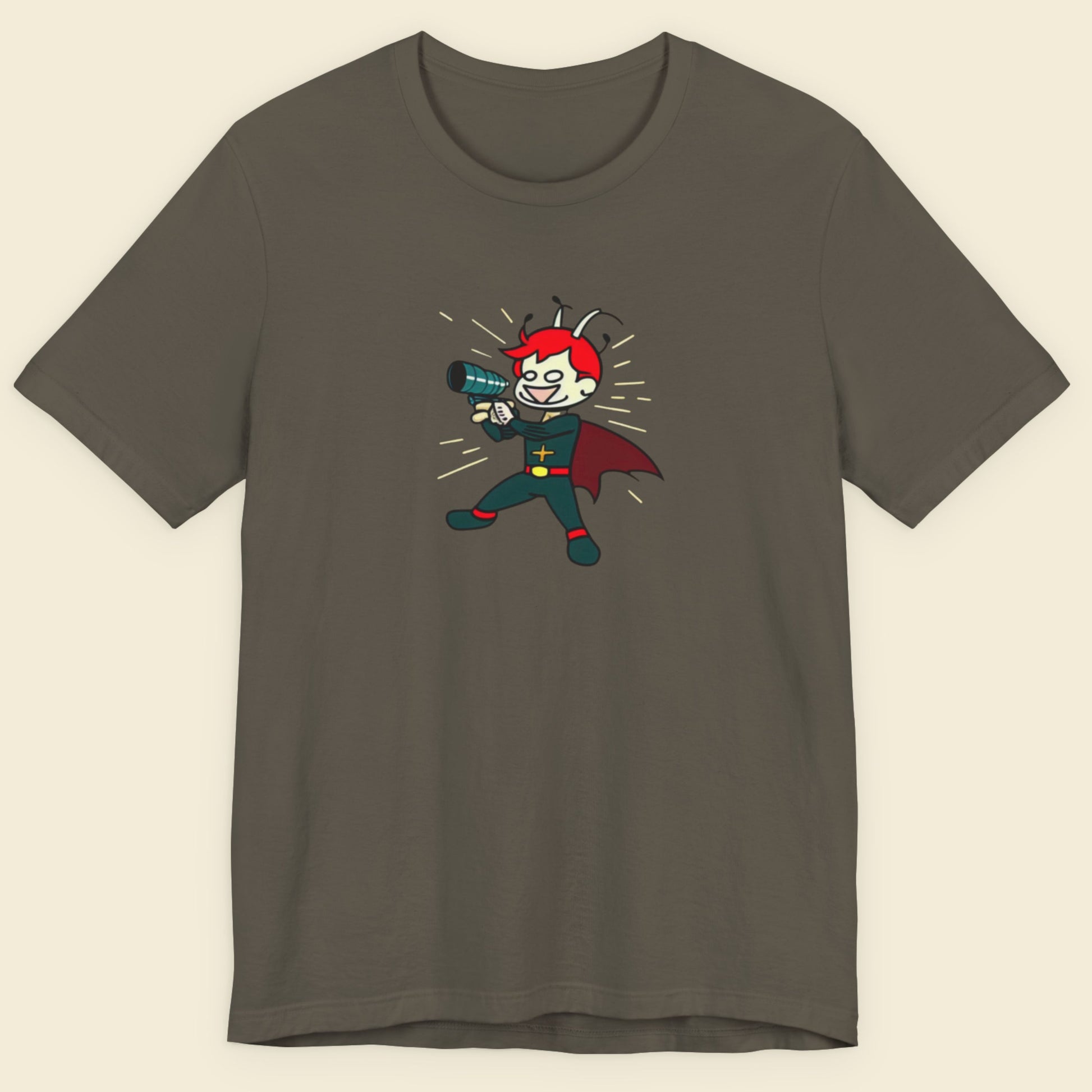 Army green t-shirt with a colorful cartoon illustration on a beige background.