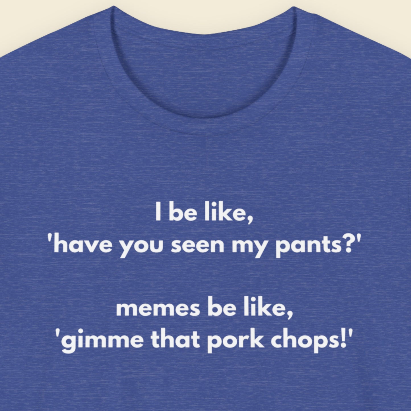 Heather blue t-shirt with humorous text on a beige background.