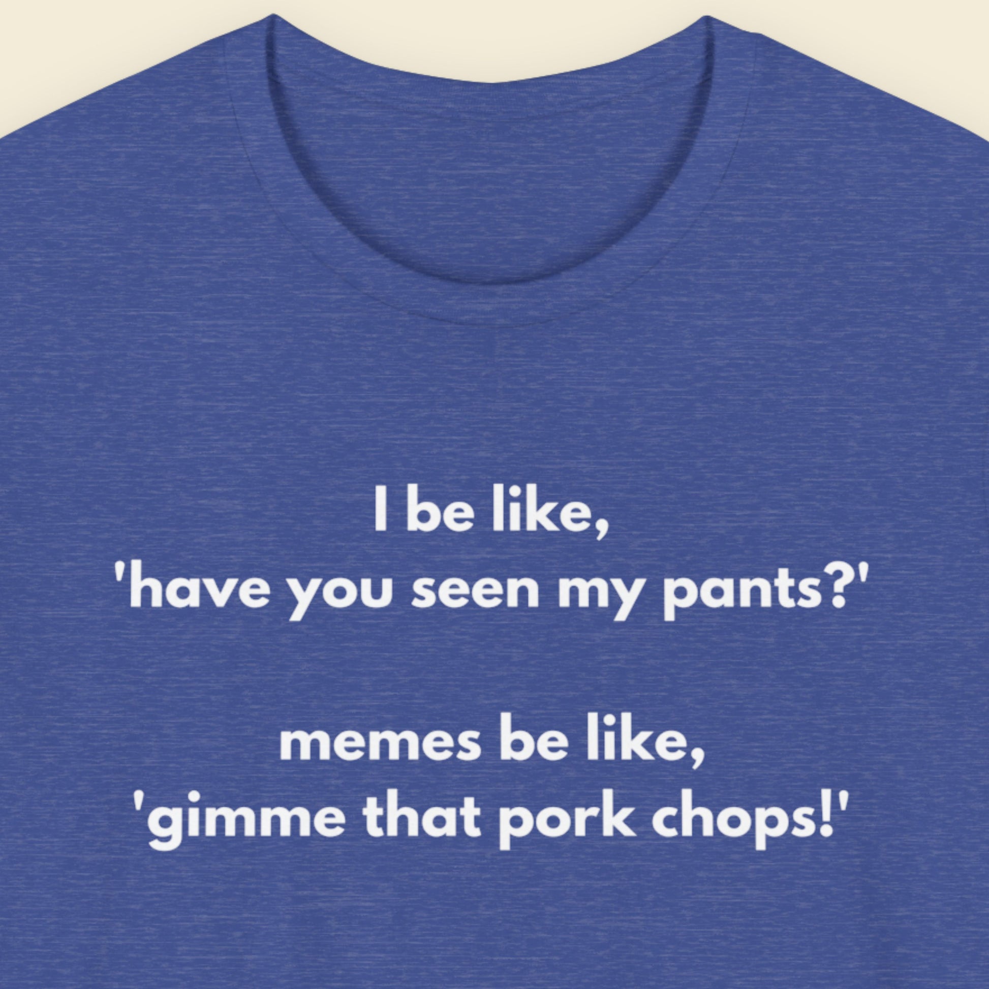 Heather blue t-shirt with humorous text on a beige background.
