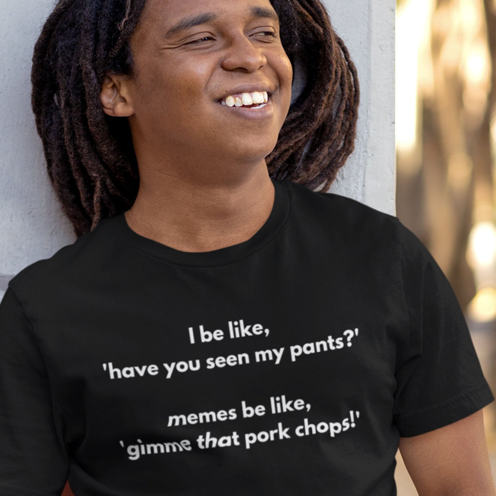 Person wearing a black t-shirt with humorous text design.