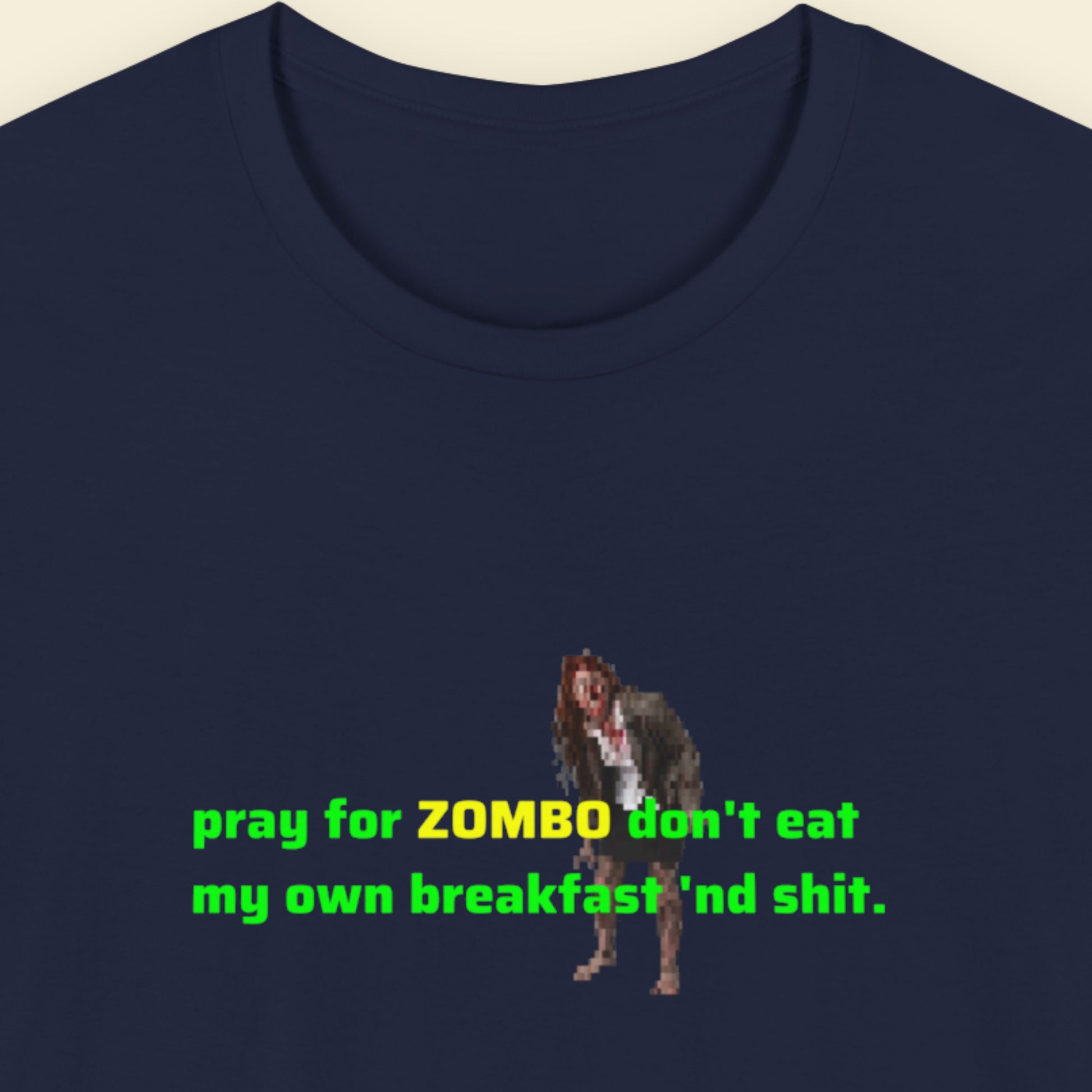 Navy blue t-shirt with a graphic of a zombie and humorous text on a beige background.