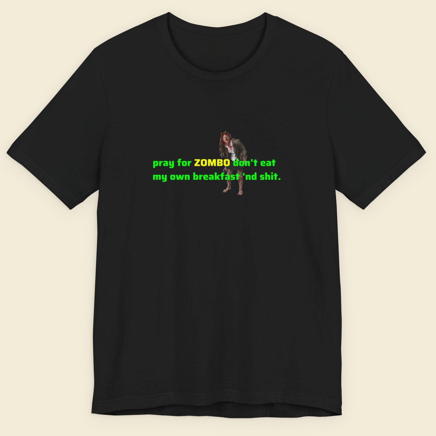 Black t-shirt with green and yellow text and graphic on a beige background.