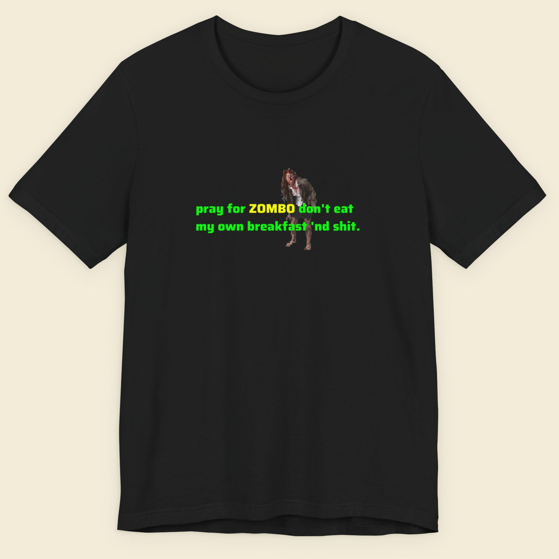 Black t-shirt with green and yellow text and graphic on a beige background.