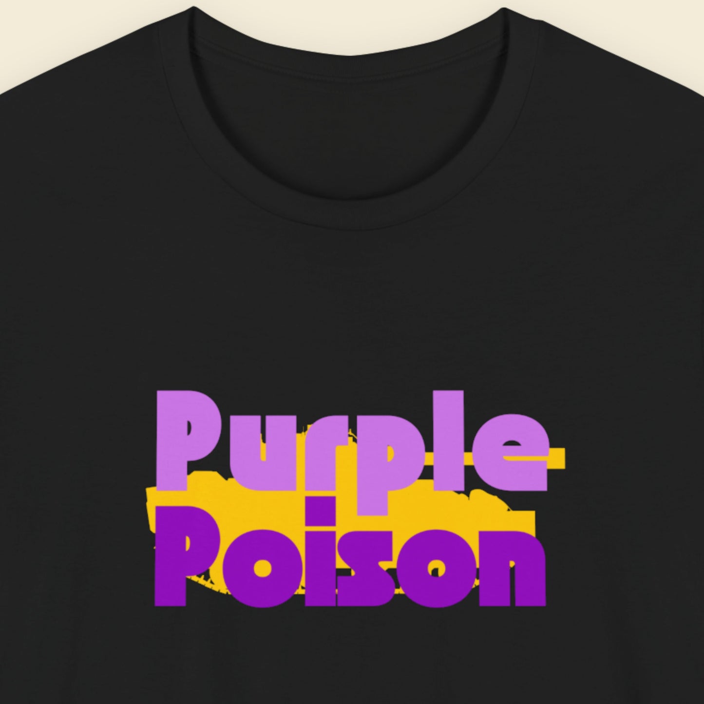 Black t-shirt with humorous colorful text on a beige background.