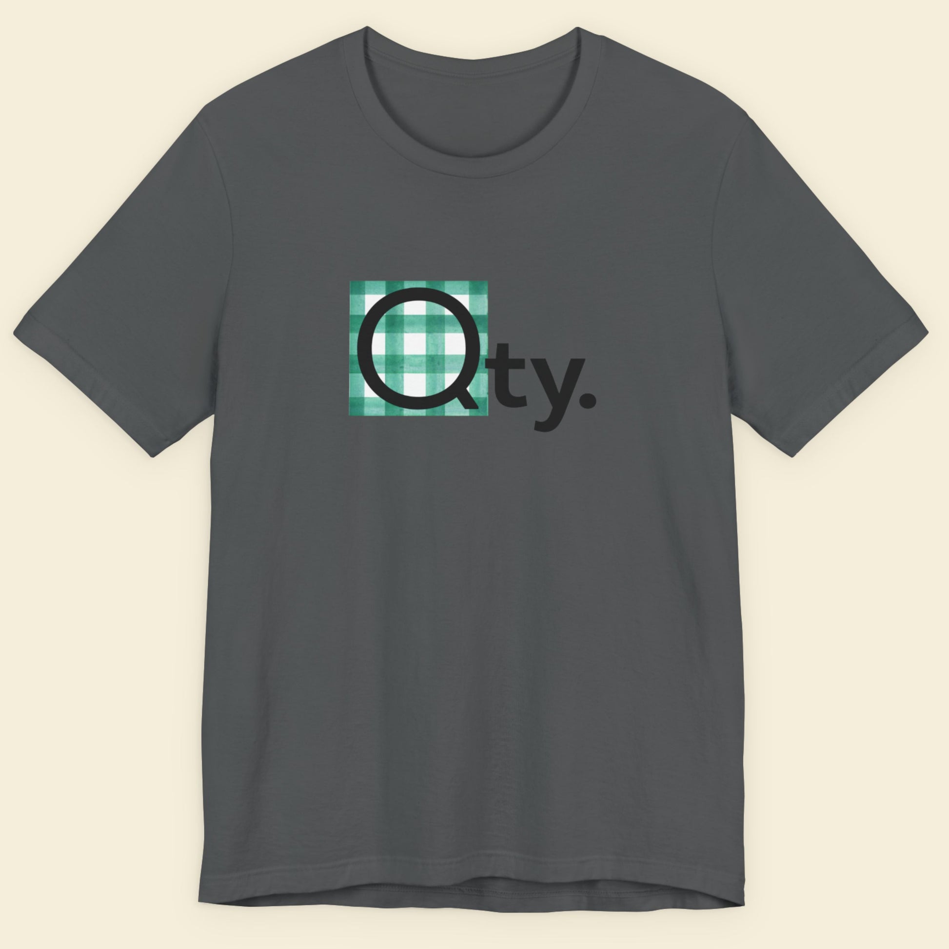 Gray t-shirt with a logo on a beige background.